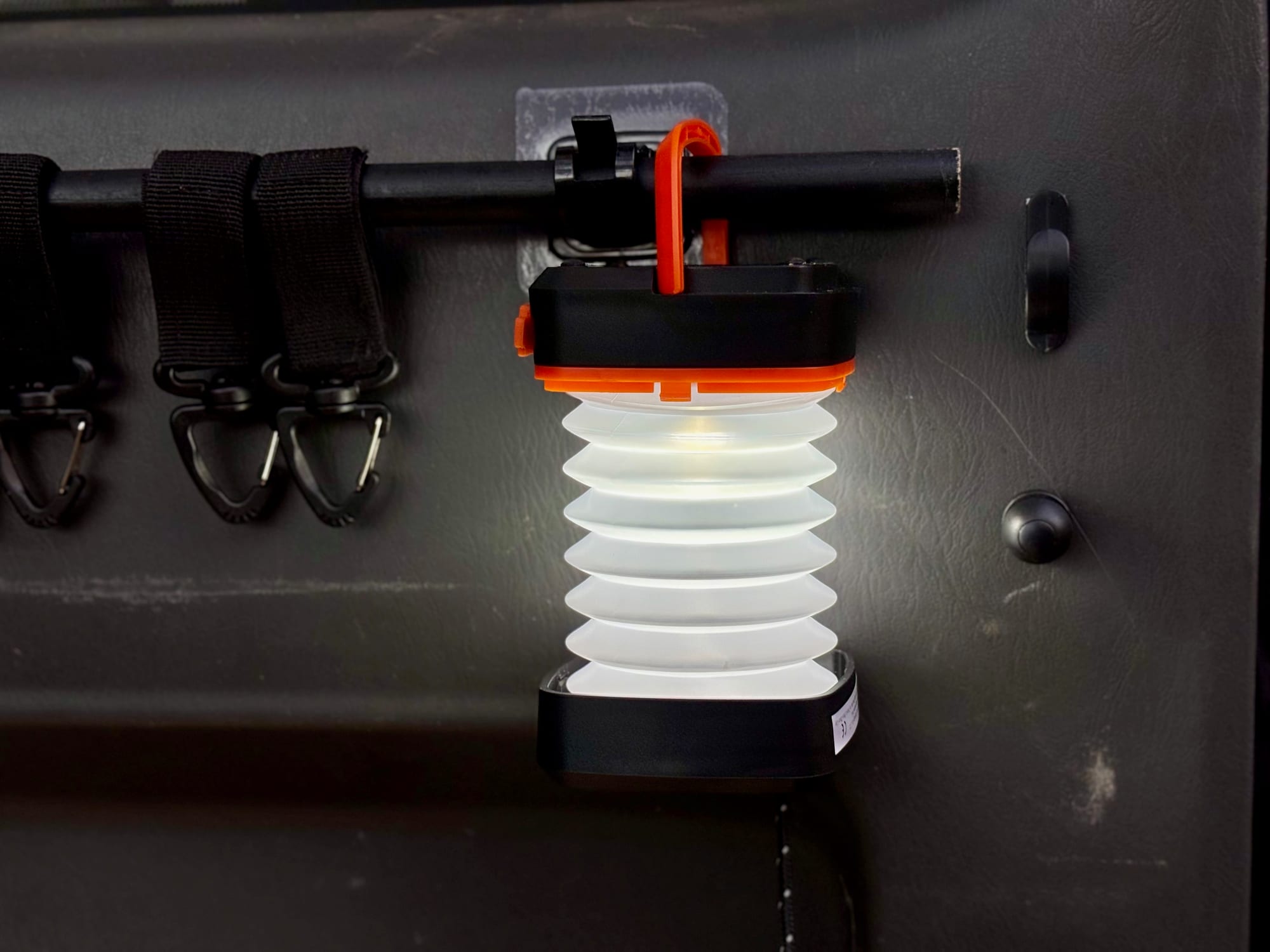 The solar lantern pulled out and hanging from a hook inside the car