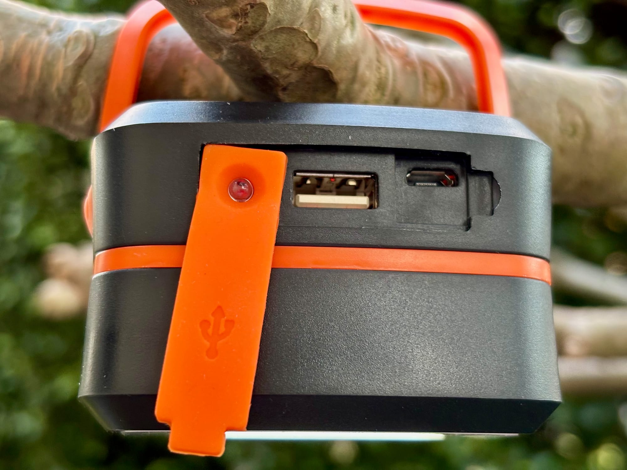 The USB-A and USB-C ports under the rubber flap on the side of the lantern