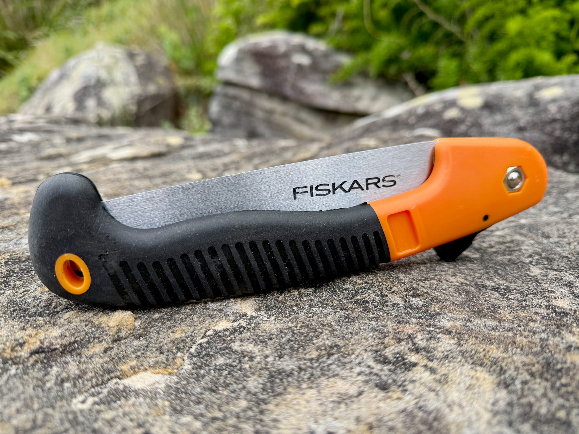 The Fiskars 7-inch saw folded, with the blade inside the curved black handle