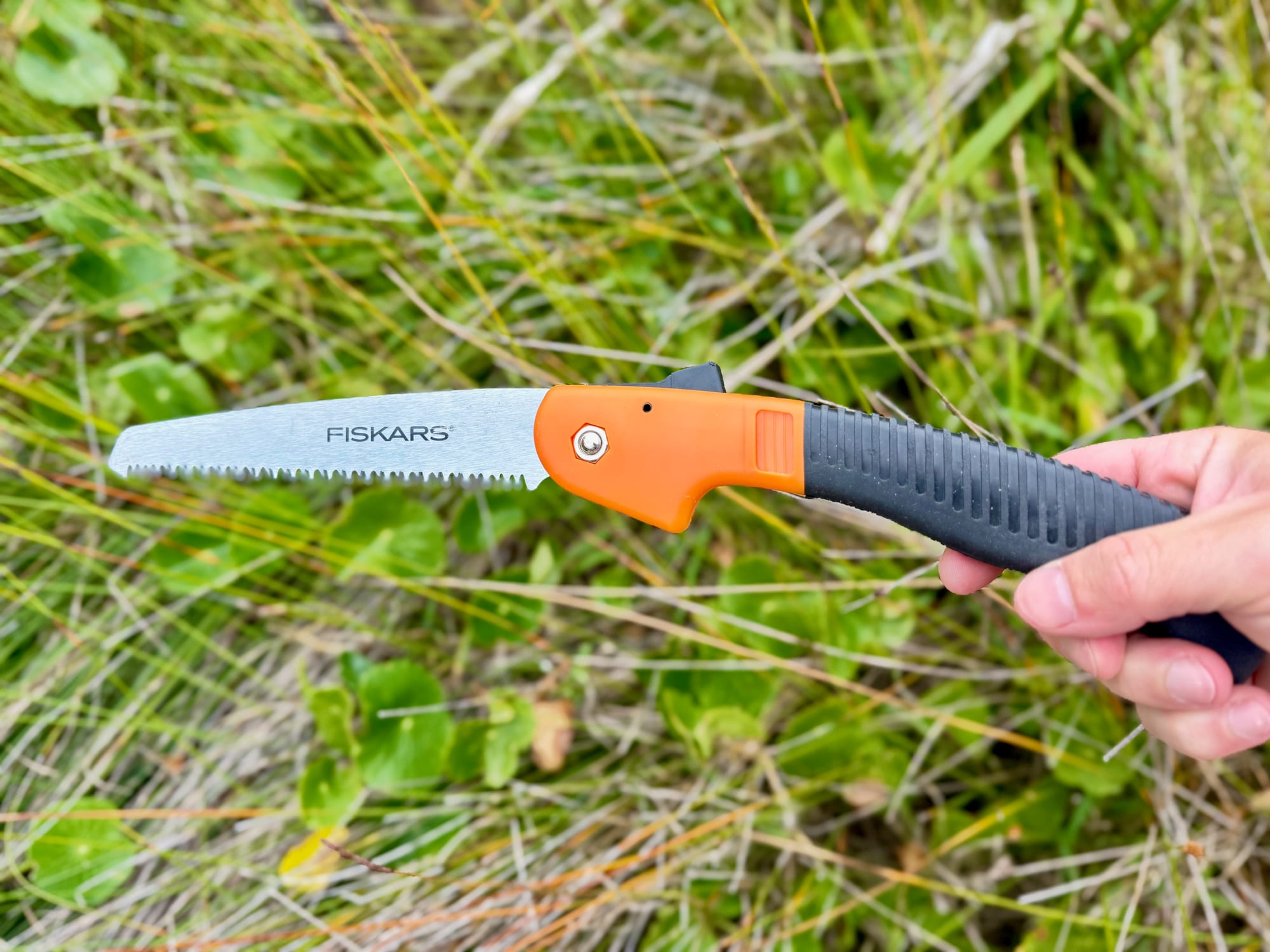 The Fiskars 7-inch saw open in a hand