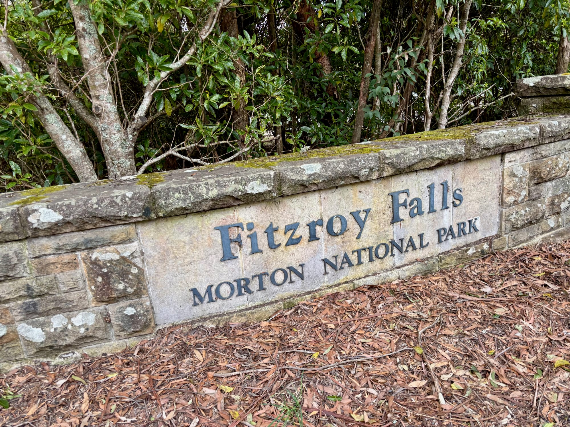 The stone wall sign reading Fitzroy Falls, Morton National Park