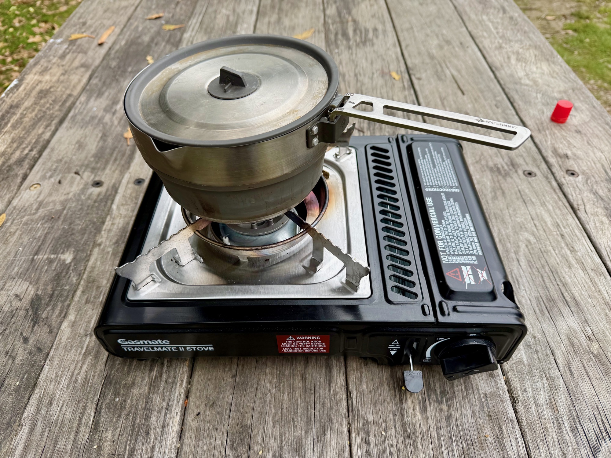 The Gasmate Travelmate II burner and pot supports from above, with a pot on top
