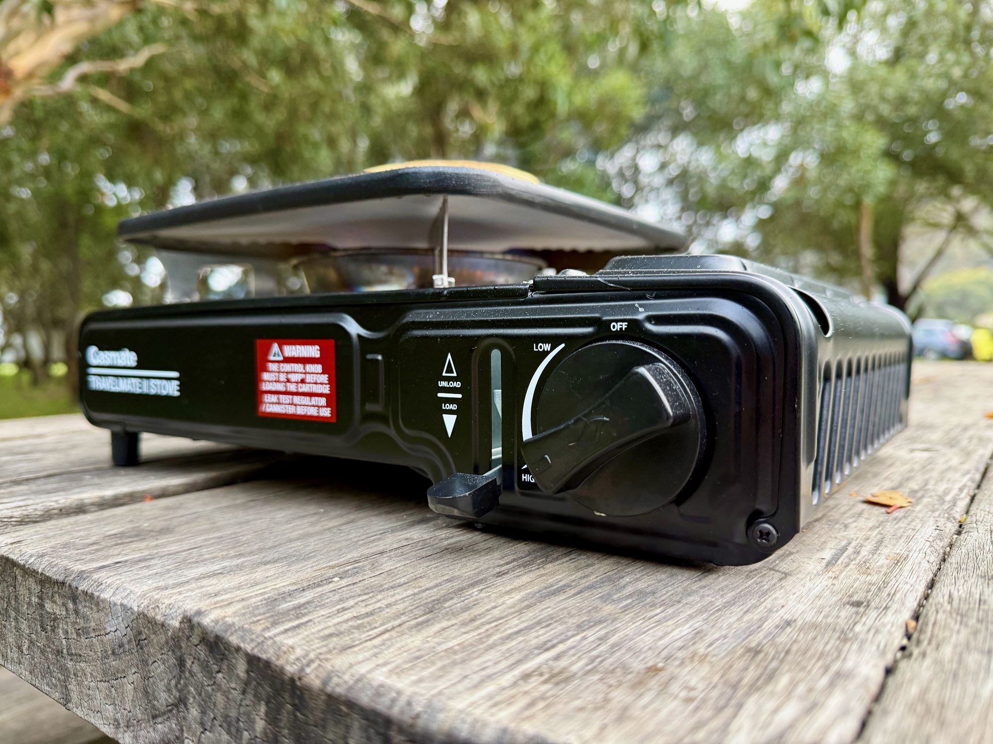 Close-up of the Gasmate Travelmate II control knob and the load/unload lever for the gas canister