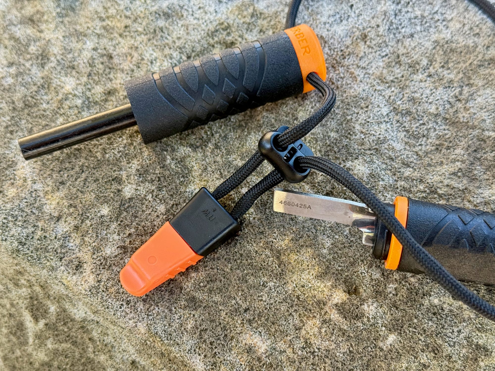 The orange whistle and the cord lock on the lanyard of the Gerber Fire Starter