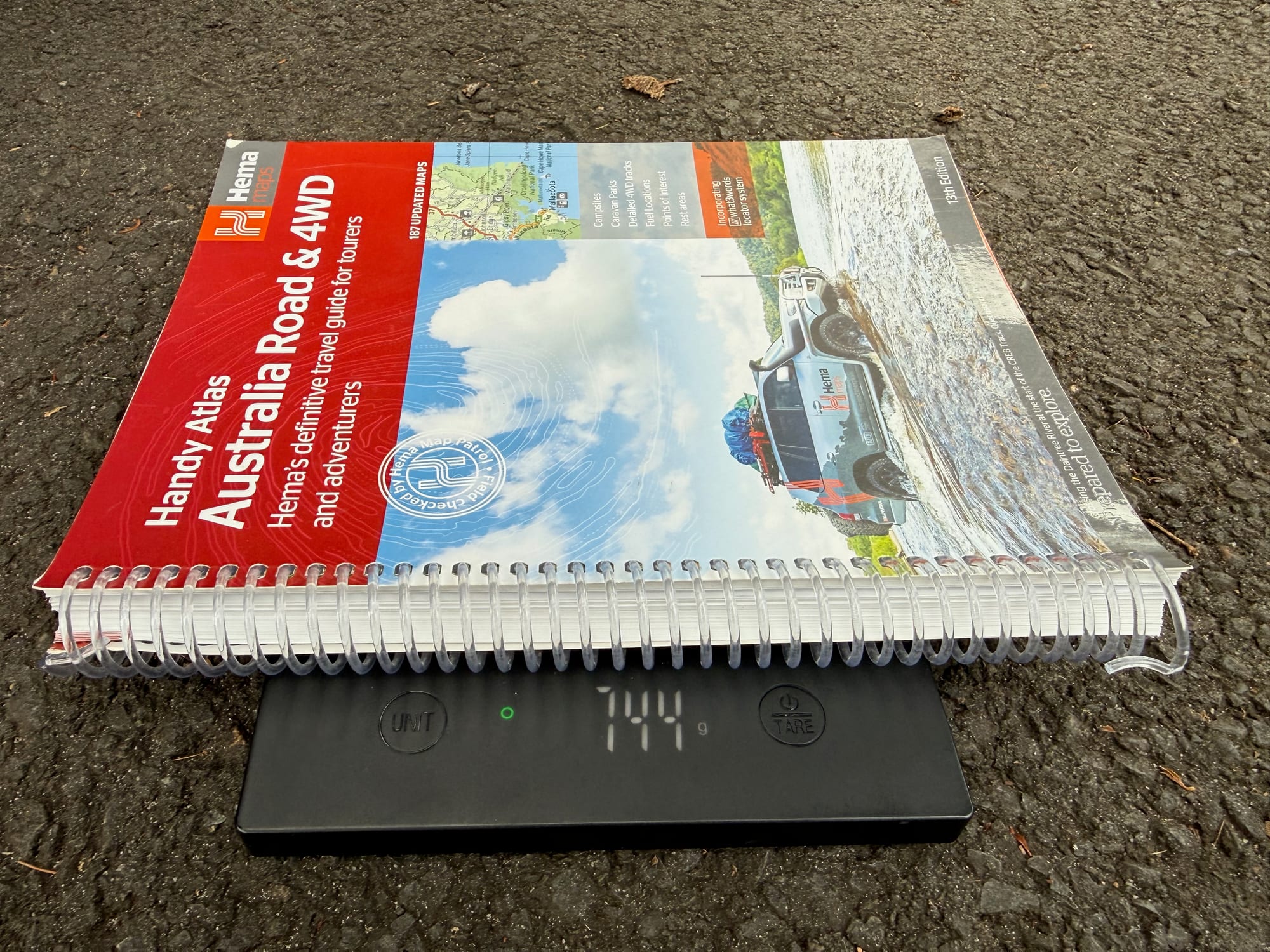 The Hema Handy Atlas on a digital scale showing 744 grams