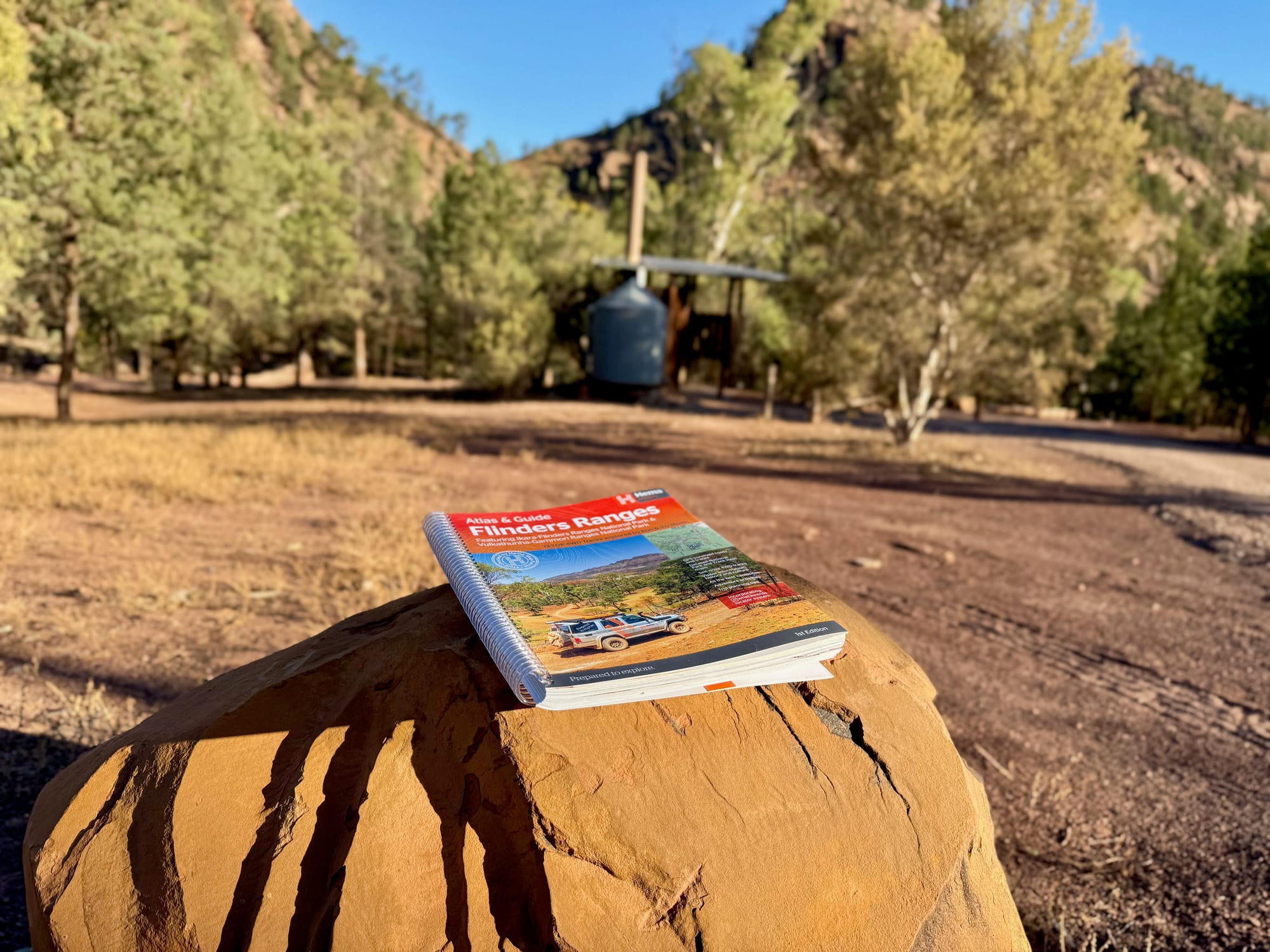 The Hema Flinders Ranges Atlas & Guide on a rock at a campsite in the Flinders Ranges