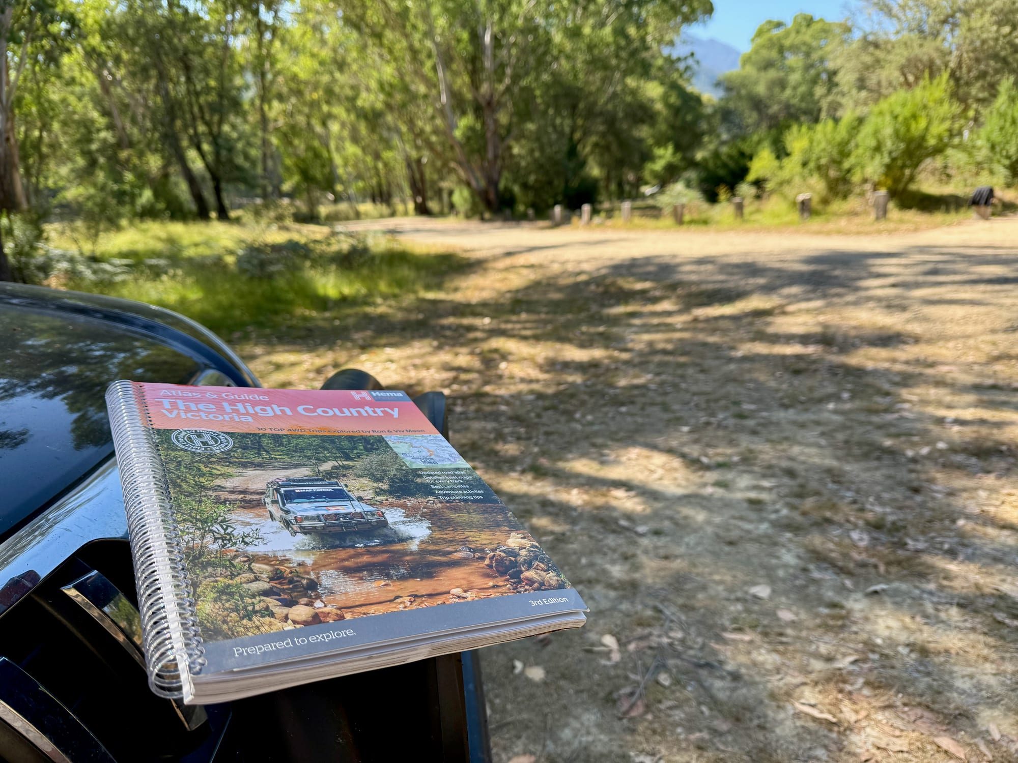The Hema High Country Victoria Atlas & Guide lying on the bonnet of the 4WD