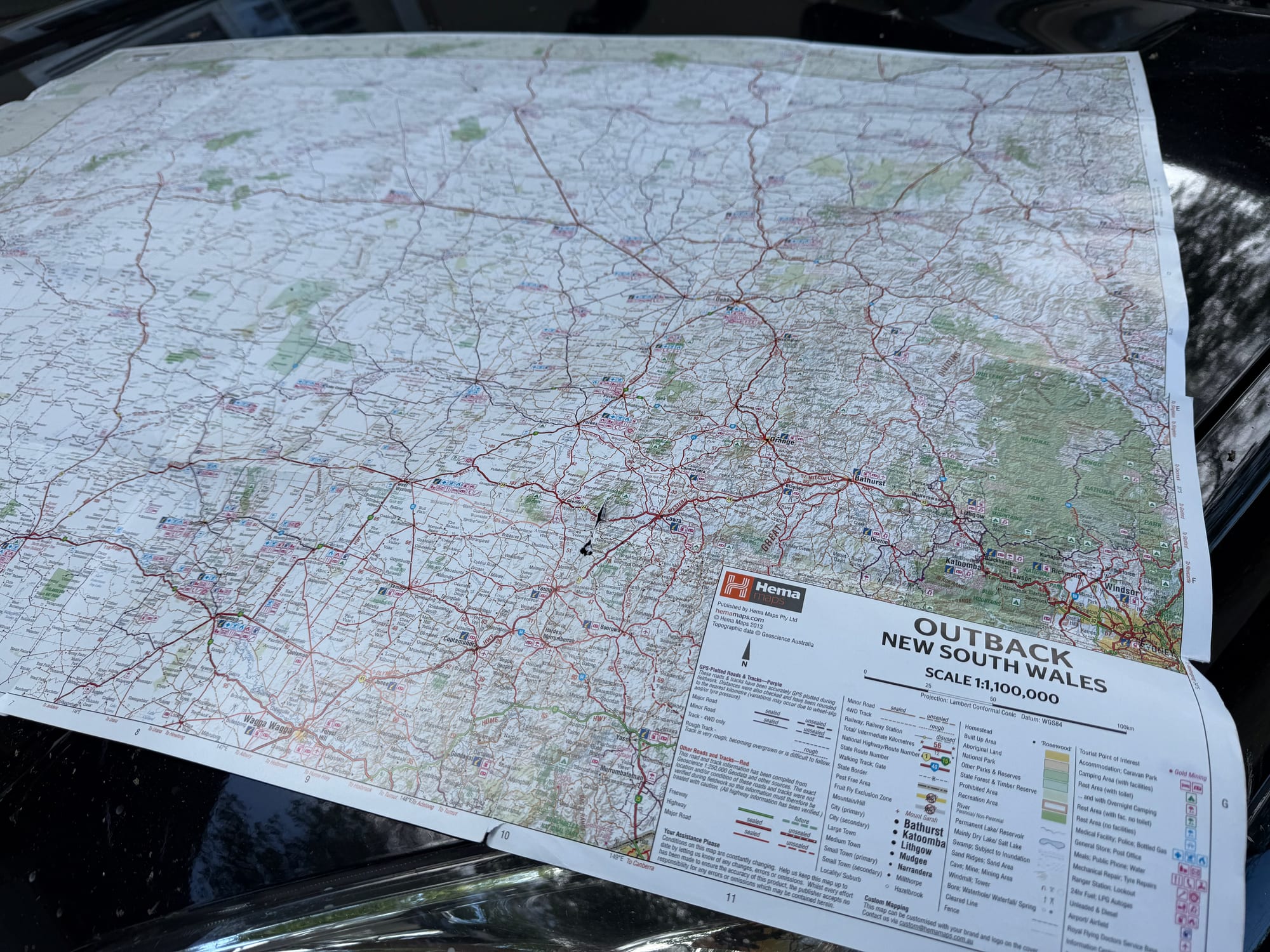 The Hema Outback New South Wales map unfolded on the bonnet of a 4WD