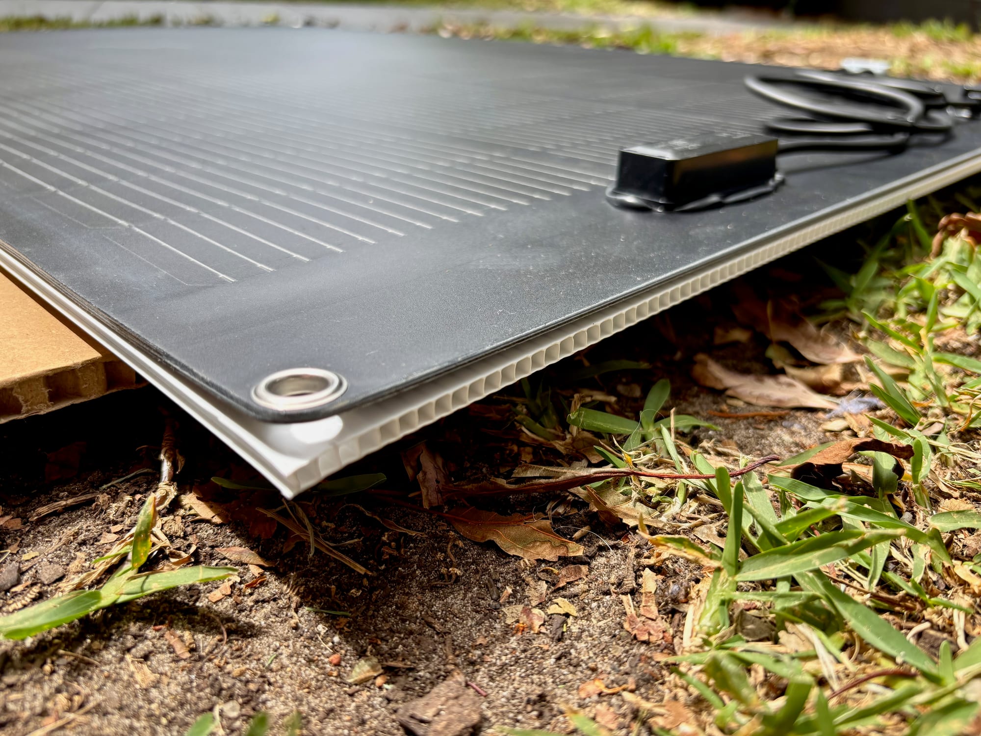 The flexible solar panel stuck to the corflute board
