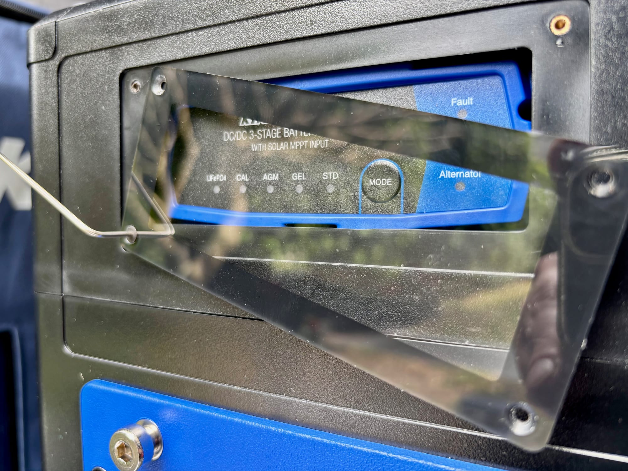 The clear cover lifted off the Kings DC-DC charger, showing the battery type lights and the Mode button
