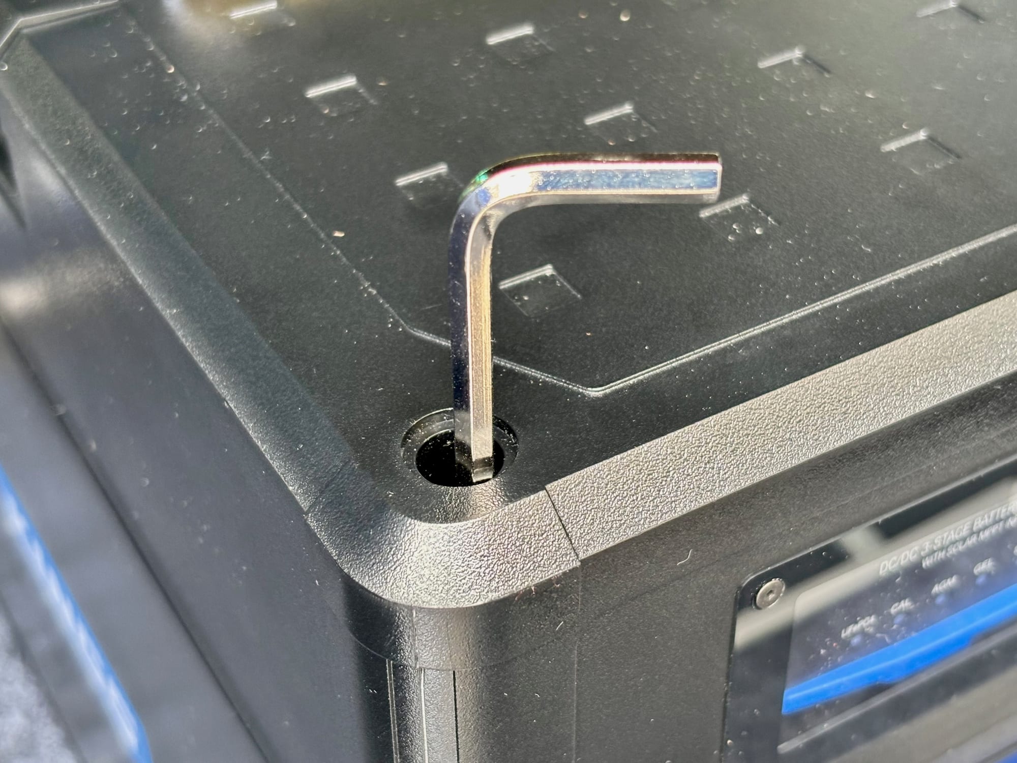 A hex key in one of the bolt holes at the corner of the BatBlock lid
