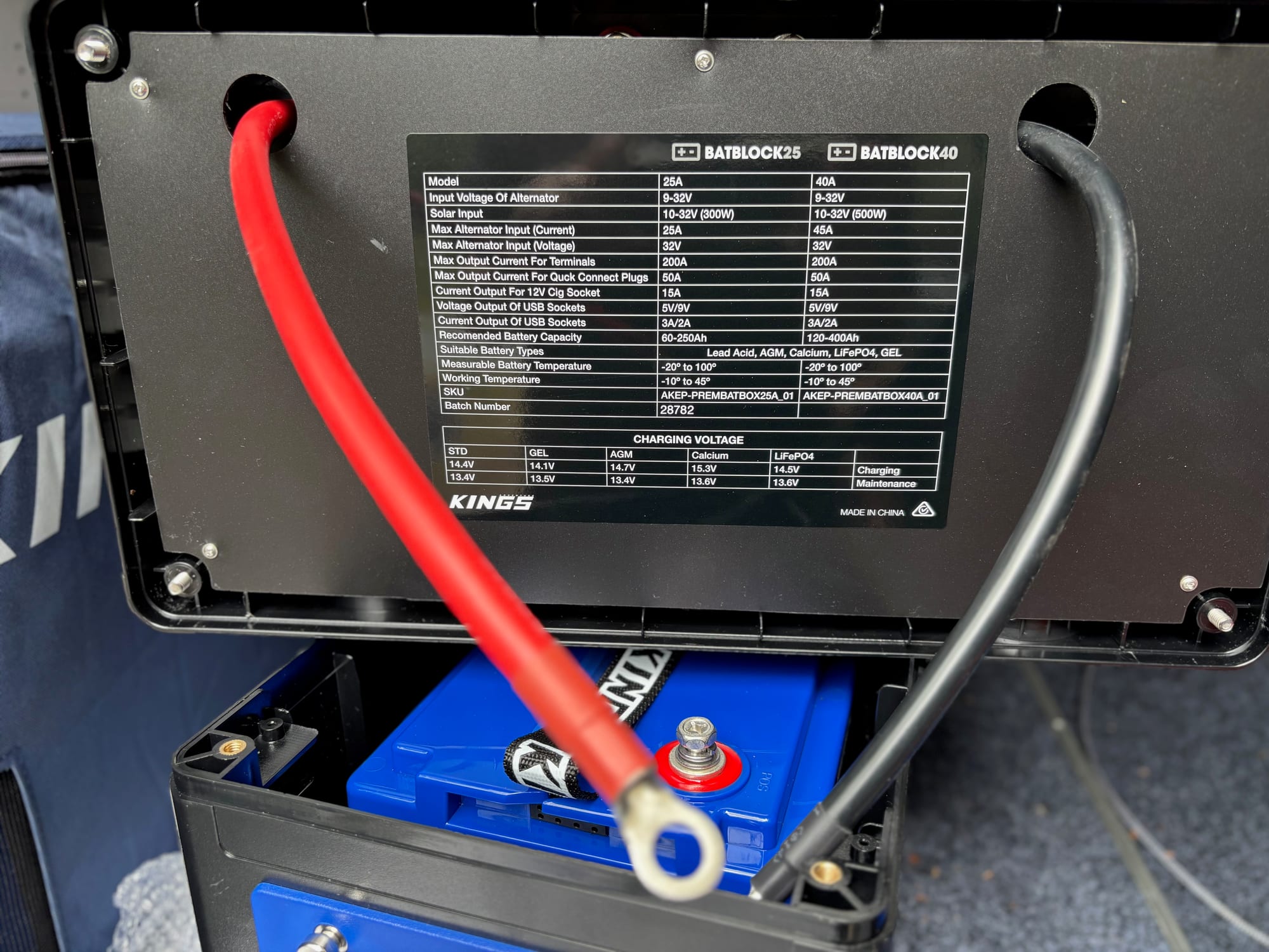 The red cable bolted to the positive terminal of the Kings lithium battery, with the BatBlock lid lifted