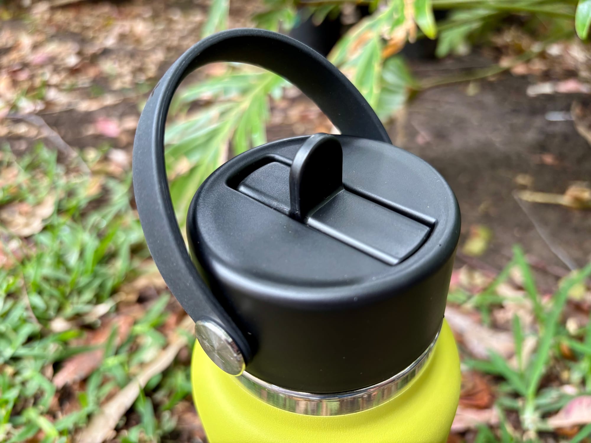 The Flex Straw Cap closed, with the spout folded down and the carry strap over the top