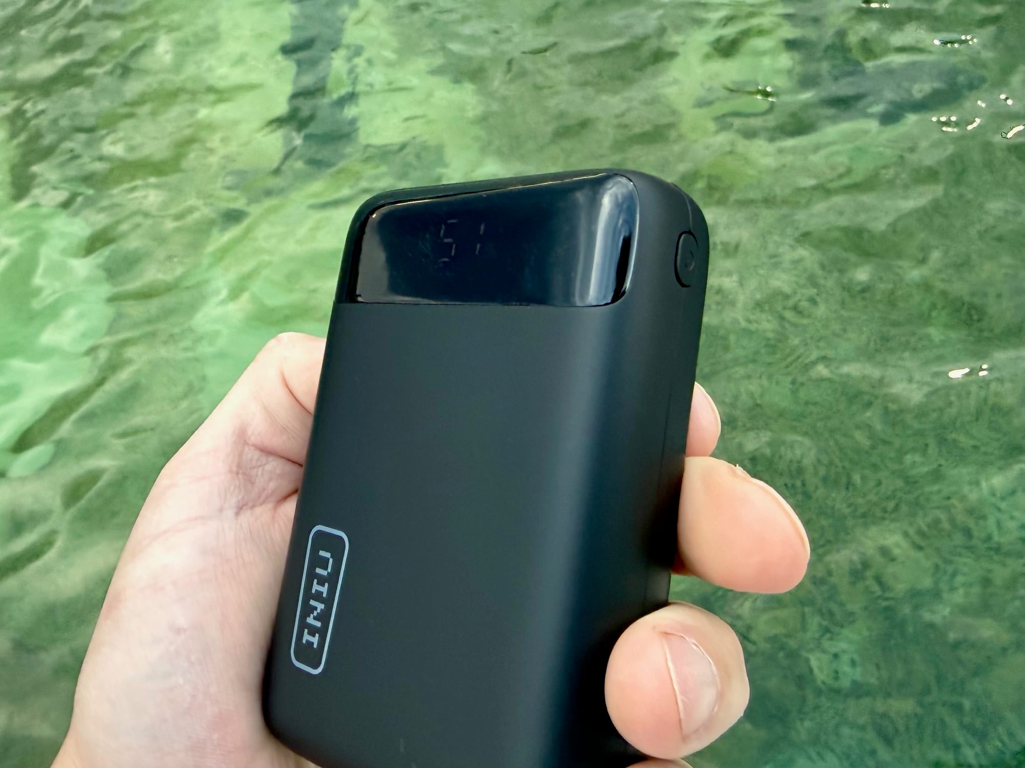 The INIU 20,000mAh power bank held in one hand