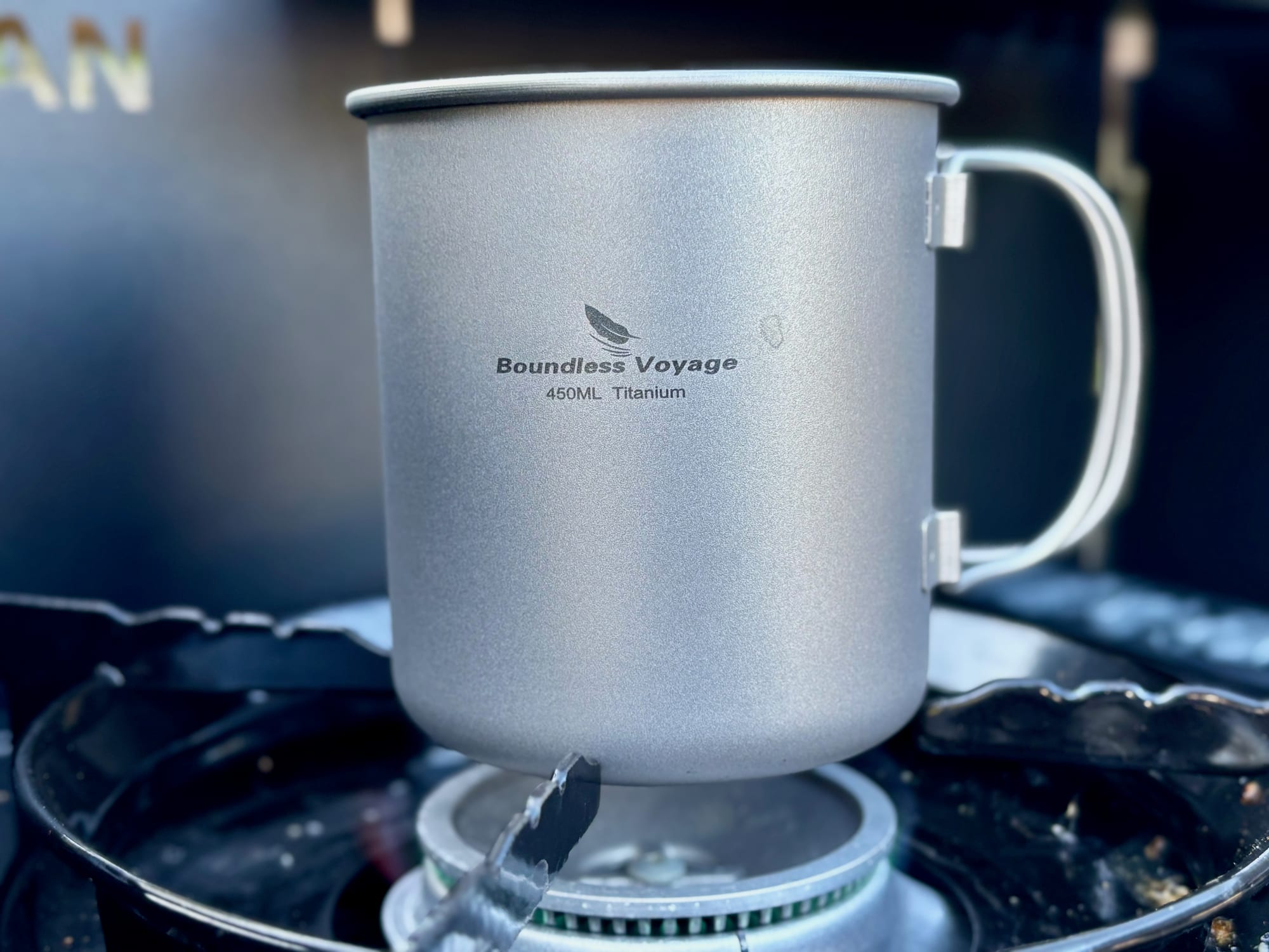 The Boundless Voyage 450 ml titanium cup sitting straight on the burner of a butane stove