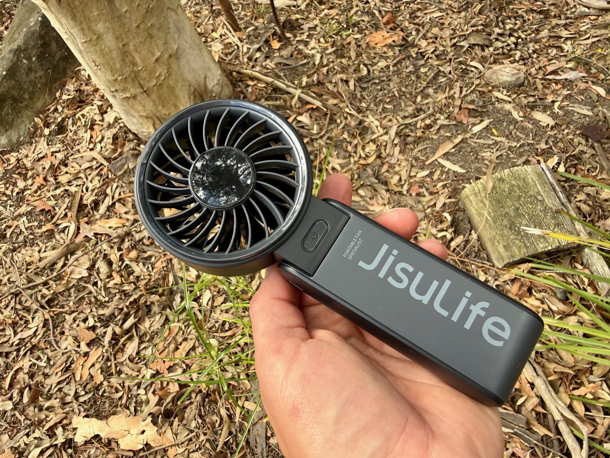 The JisuLife Life7 held in one hand in the bush