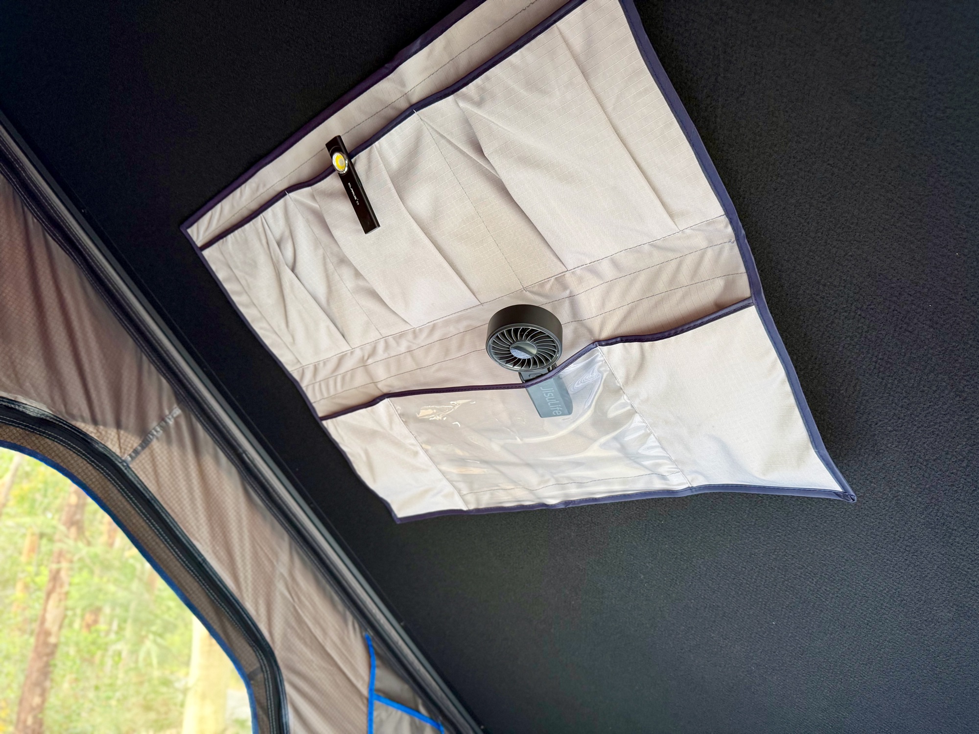 The JisuLife Life7 in the ceiling pocket, seen from inside the rooftop tent