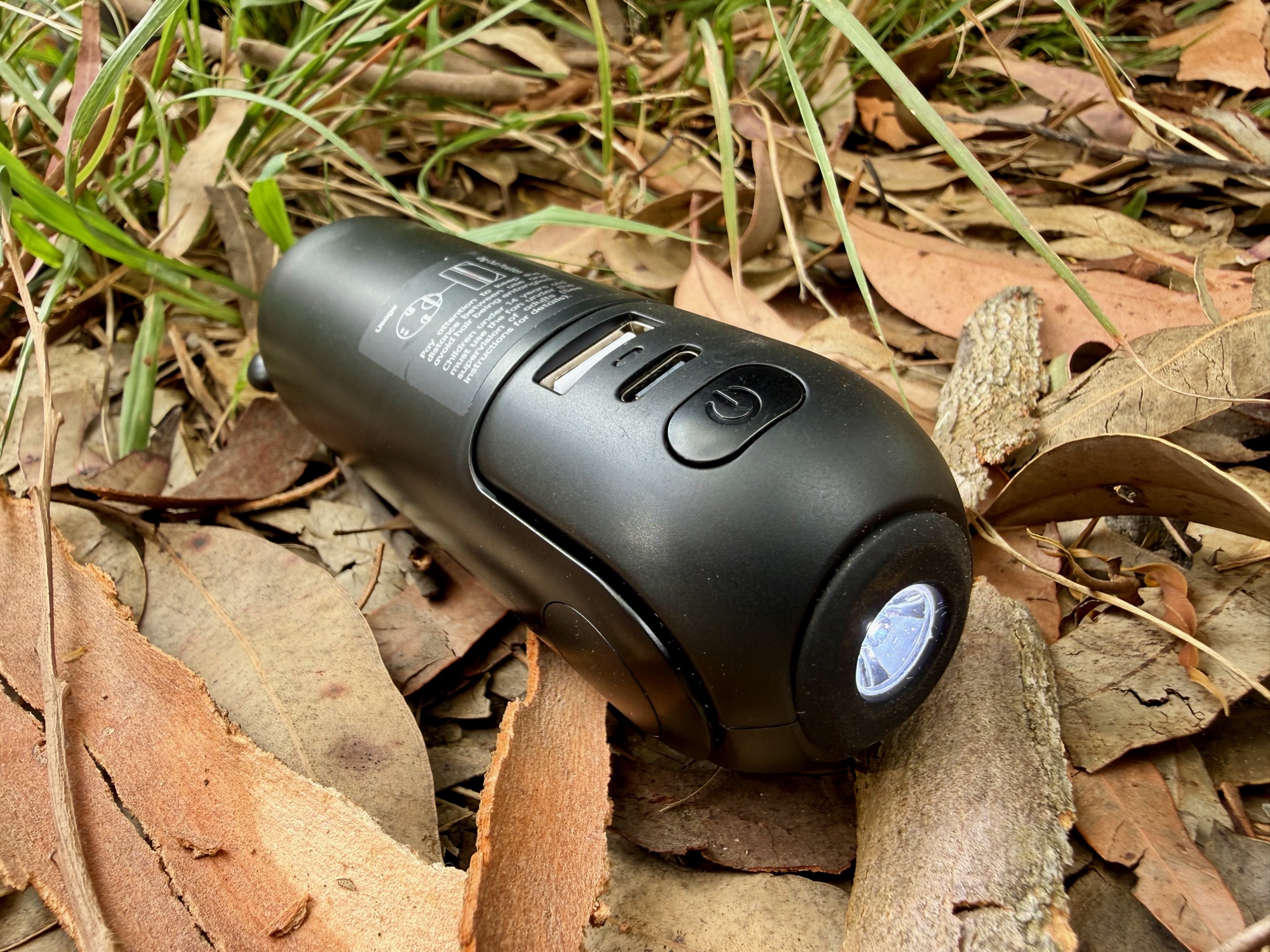 The power button, ports and lit torch of the JisuLife Life8 Plus