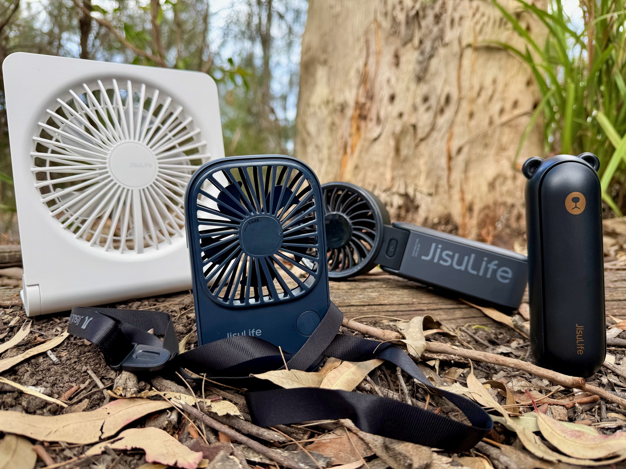 The white JisuLife Table Fan Life3 behind the other three JisuLife fans