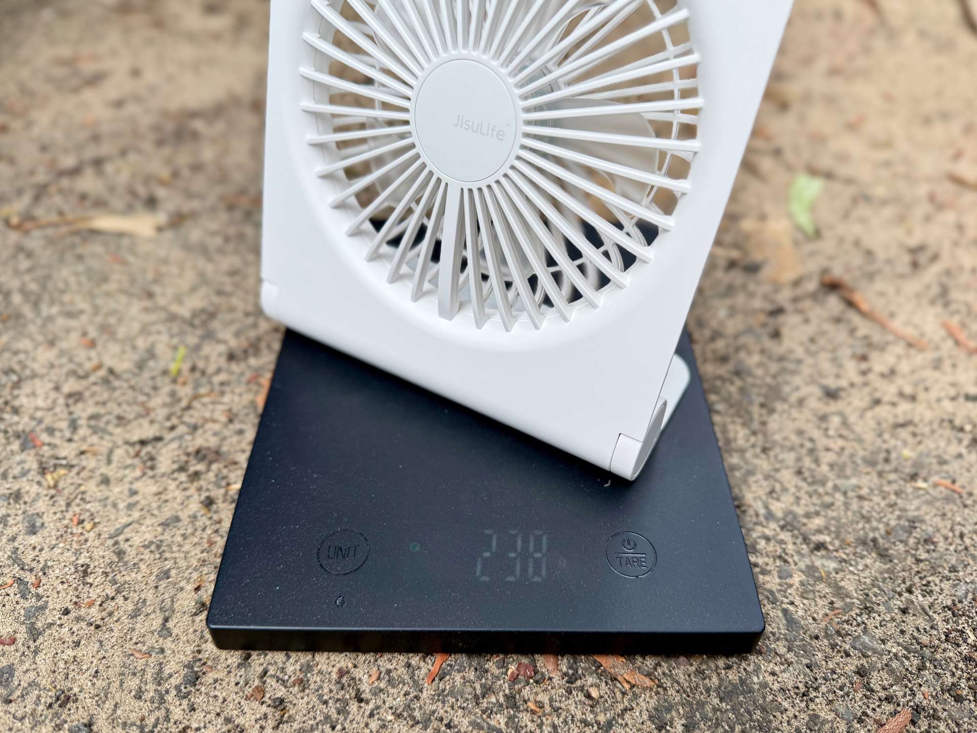 The JisuLife Table Fan Life3 on a kitchen scale showing 238 g