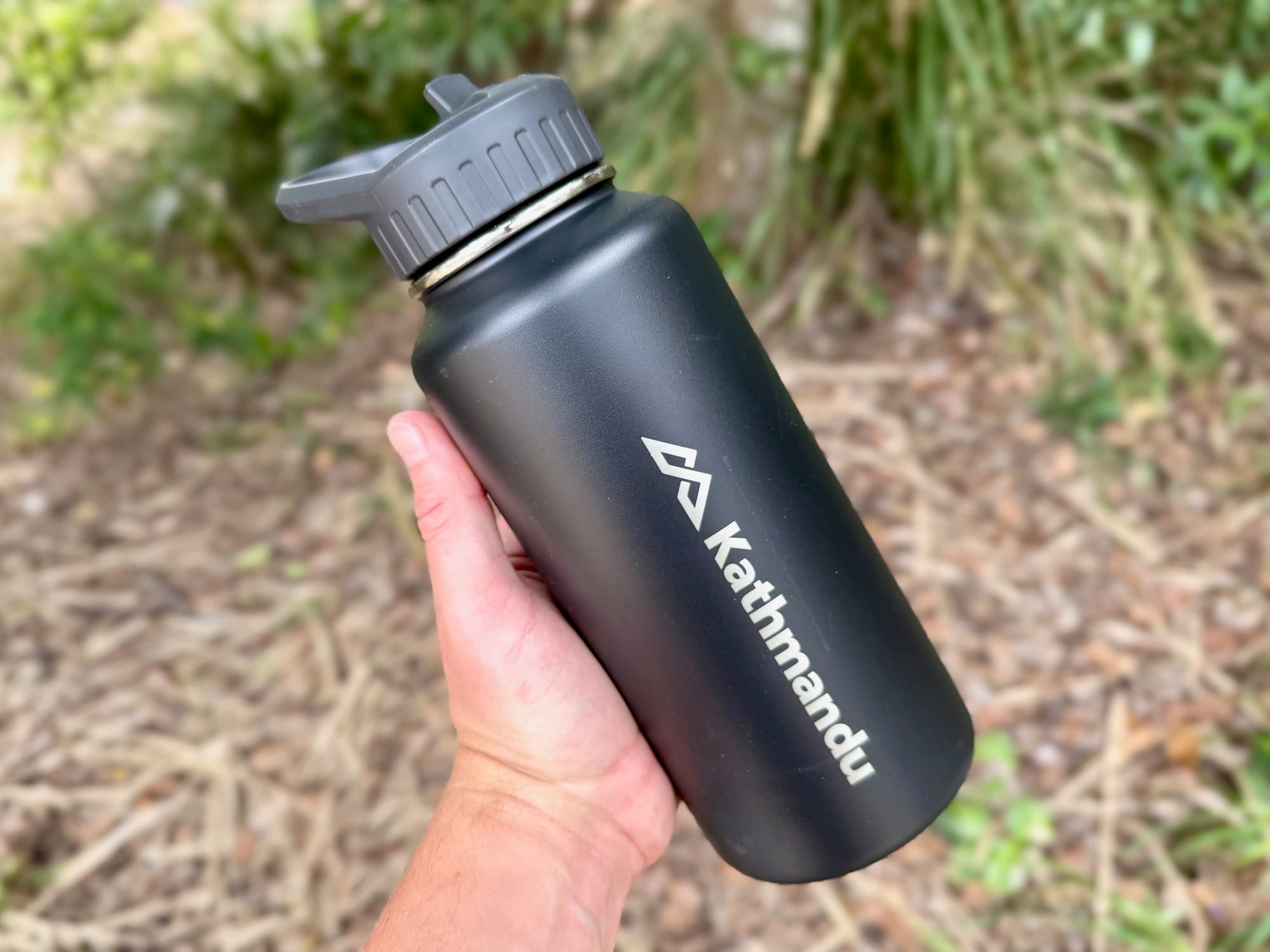 The Kathmandu insulated bottle held in one hand