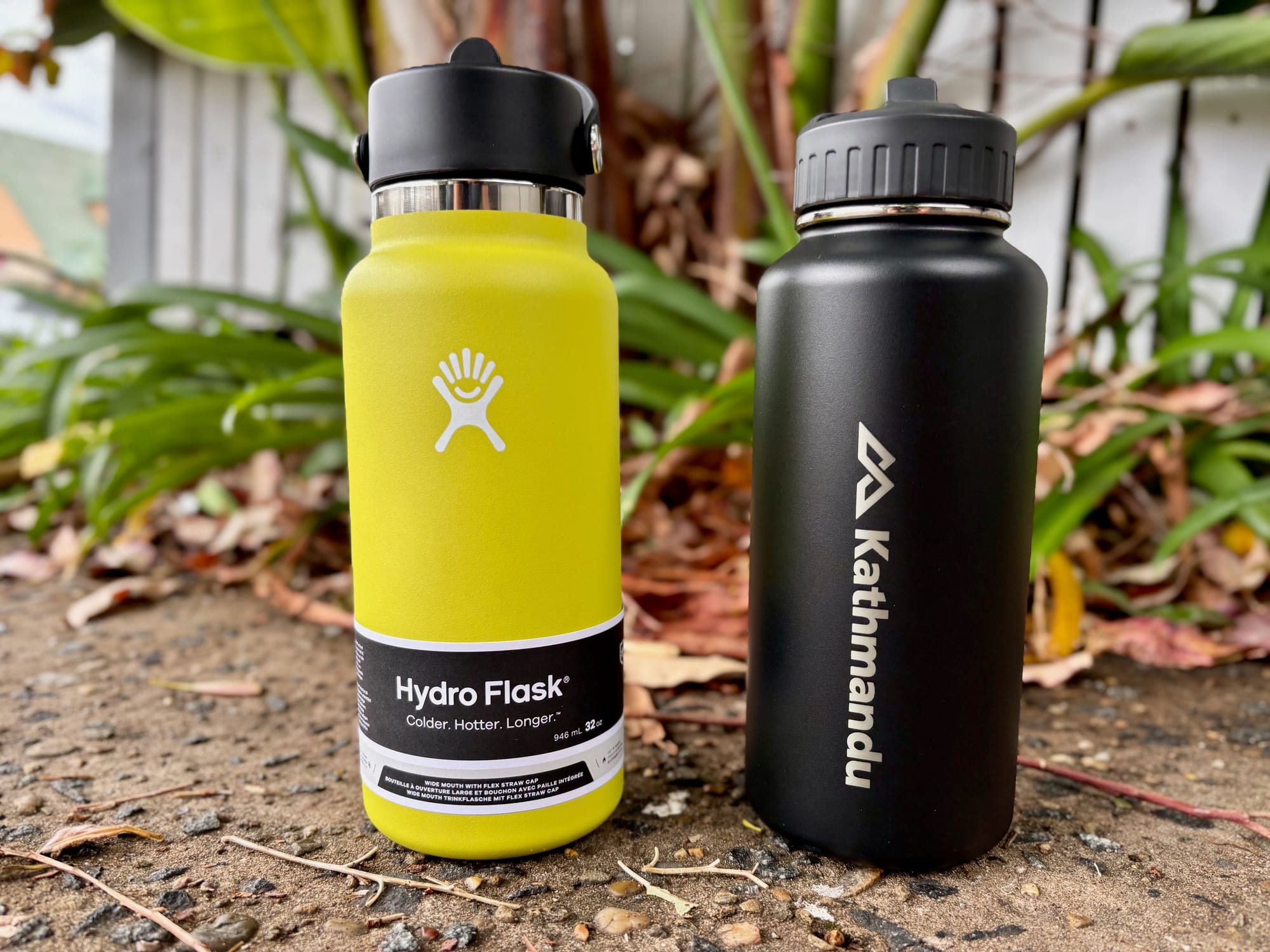 The Kathmandu Straw Lid Insulated Bottle next to the Hydro Flask 32 oz, both with their lids closed