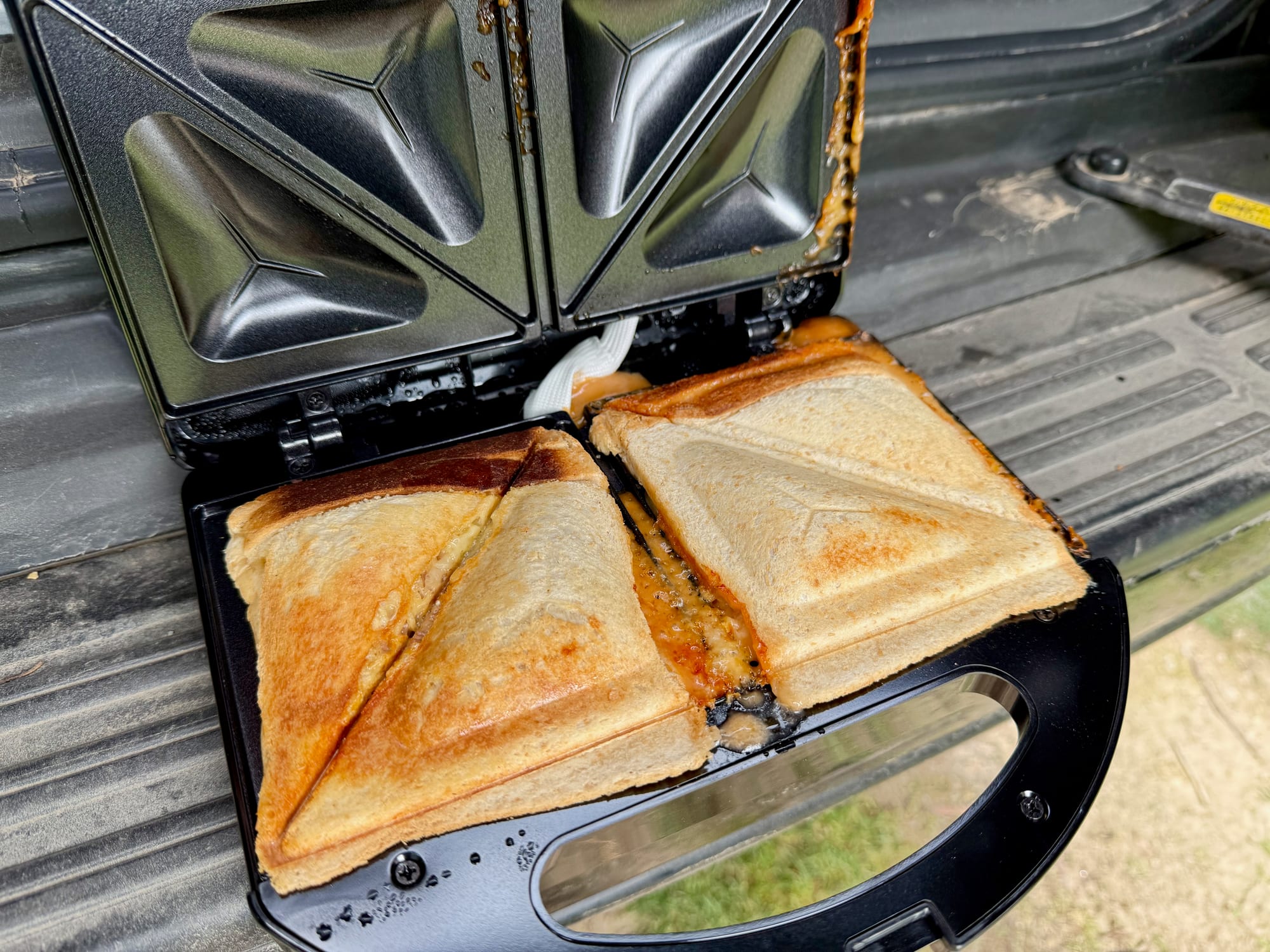Filling that has squeezed out around the jaffles and onto the hinge of the KickAss jaffle maker