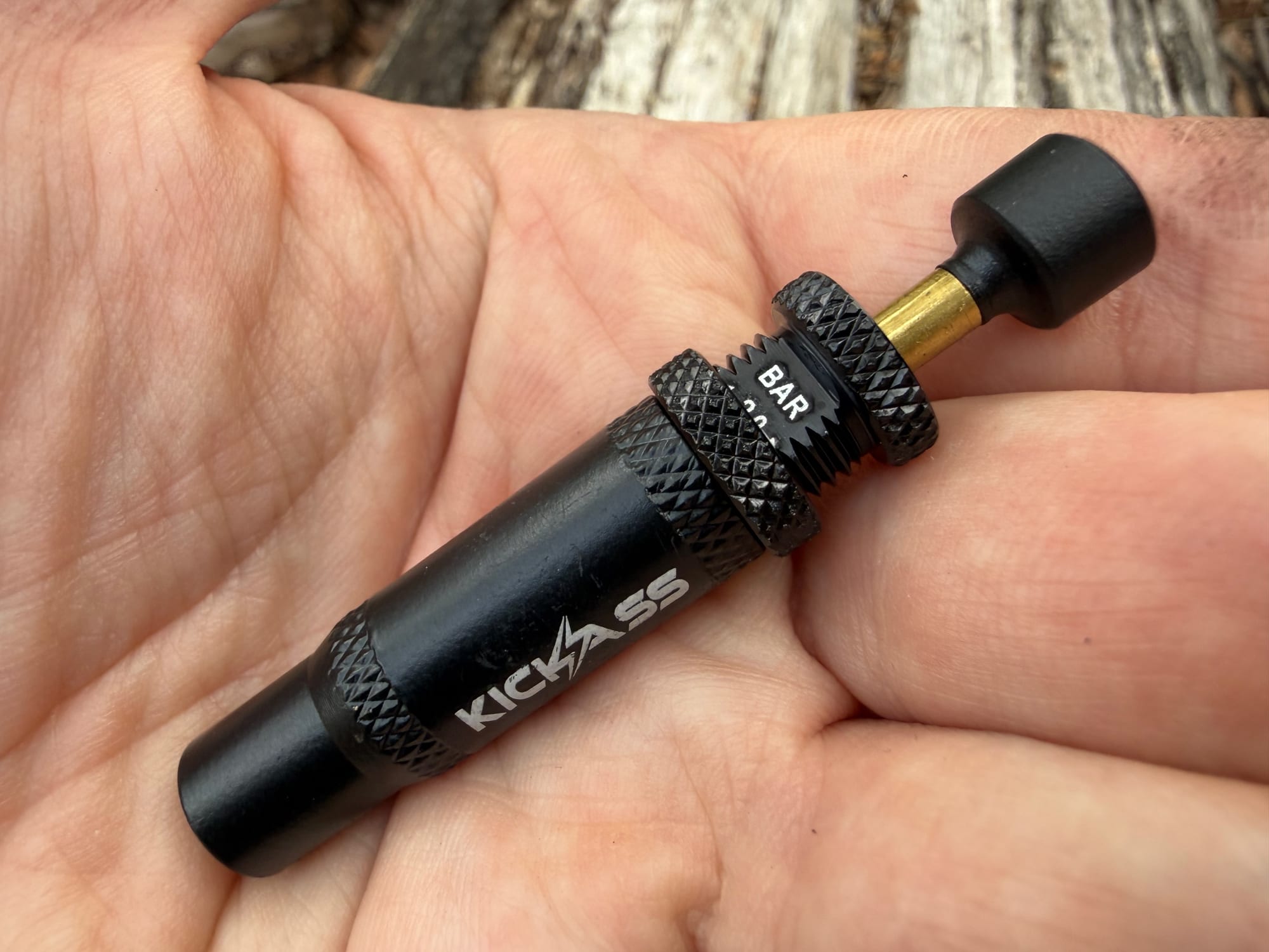 The other side of a KickAss deflator, showing the BAR scale above the lock ring