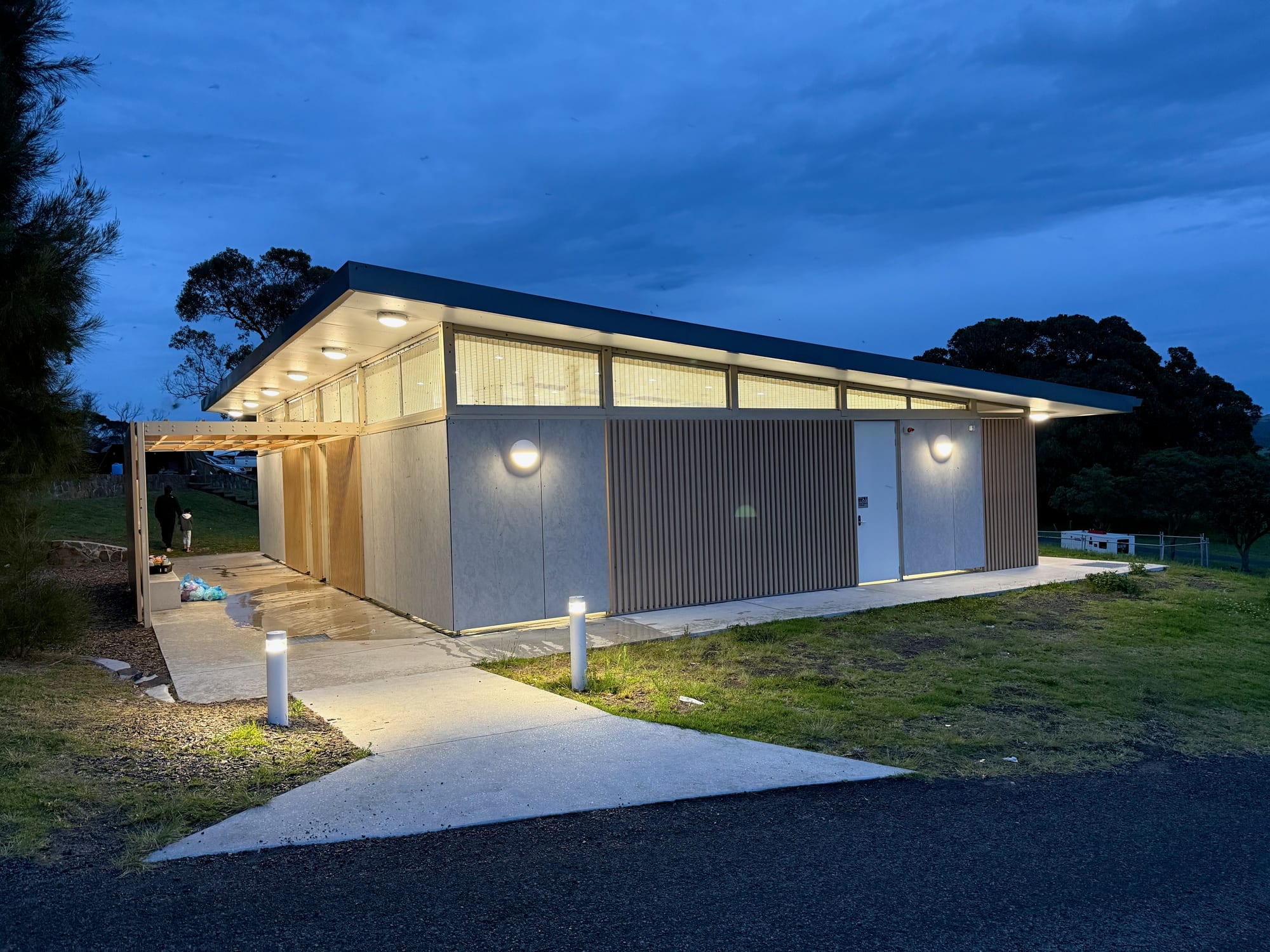 The modern amenities block at Killalea Campground, lit up at dusk