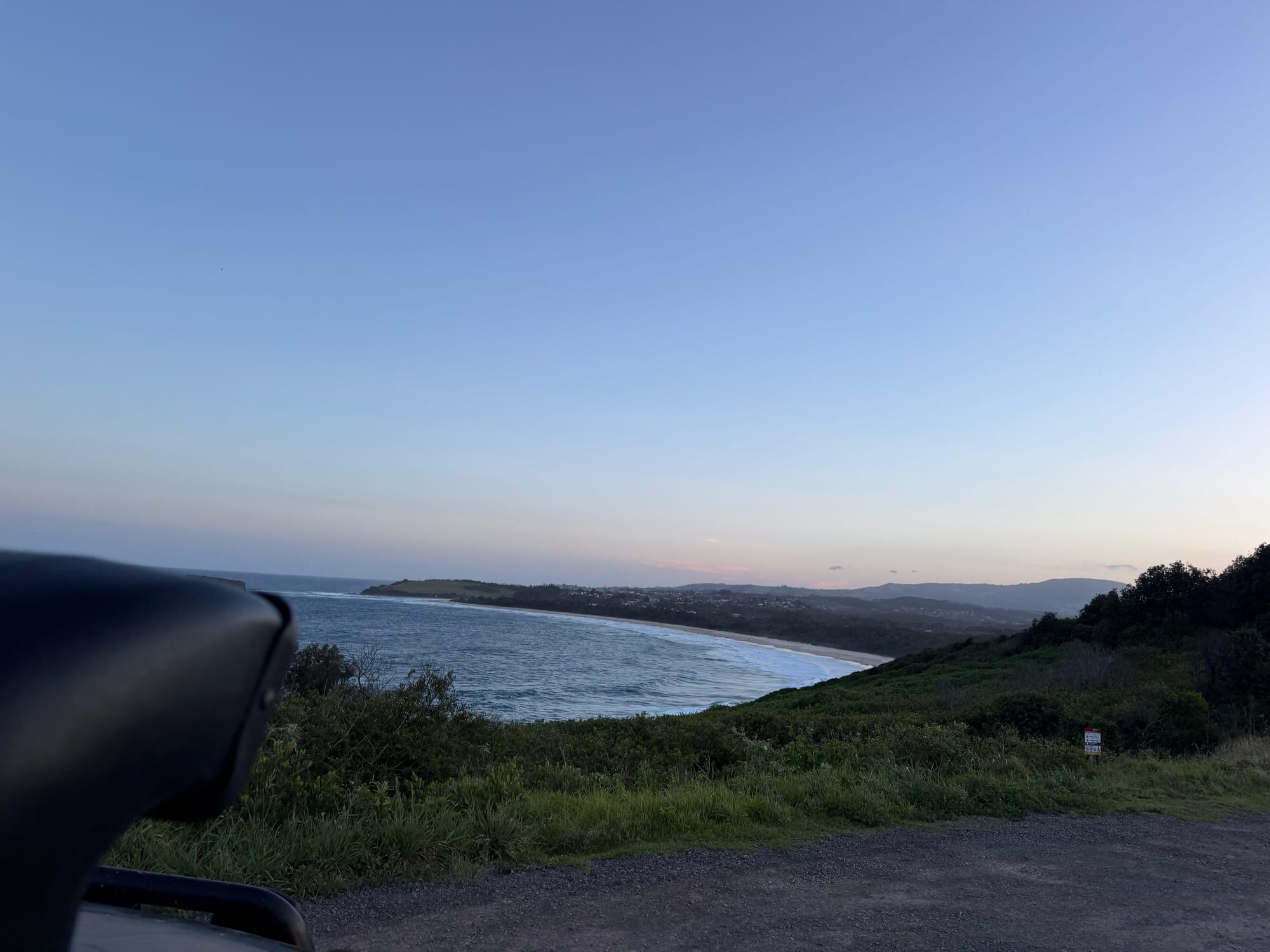 The coastline below Killalea Regional Park at dusk, seen from the road in