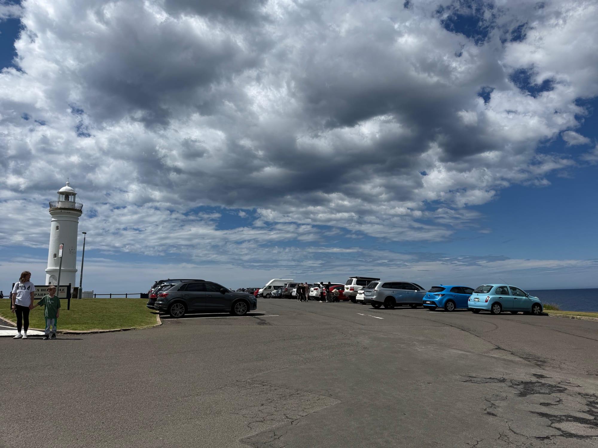The white Kiama Lighthouse on the headland next to the car park