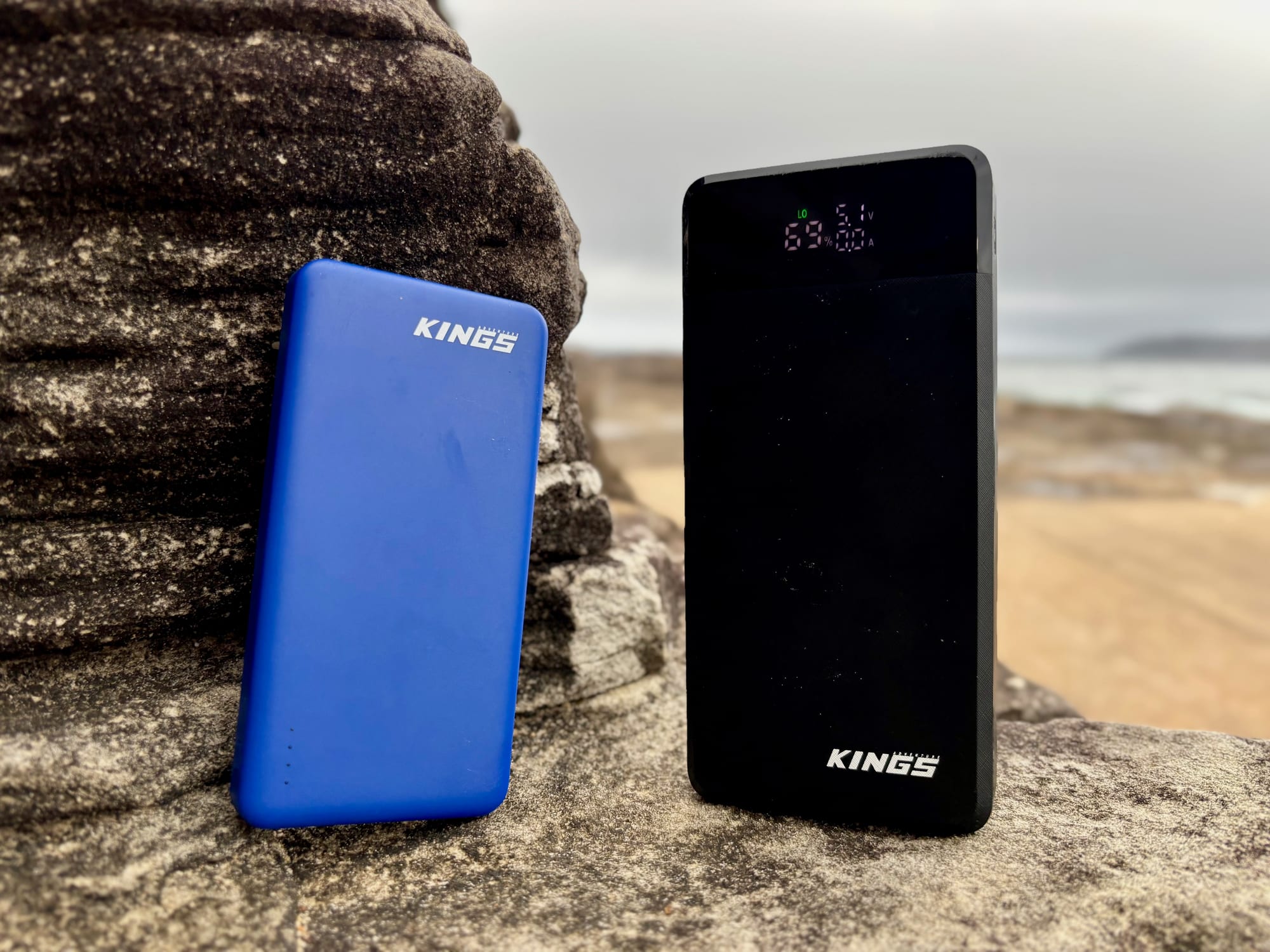 The blue Kings 10,000mAh power bank next to the black Kings 20,000mAh power bank