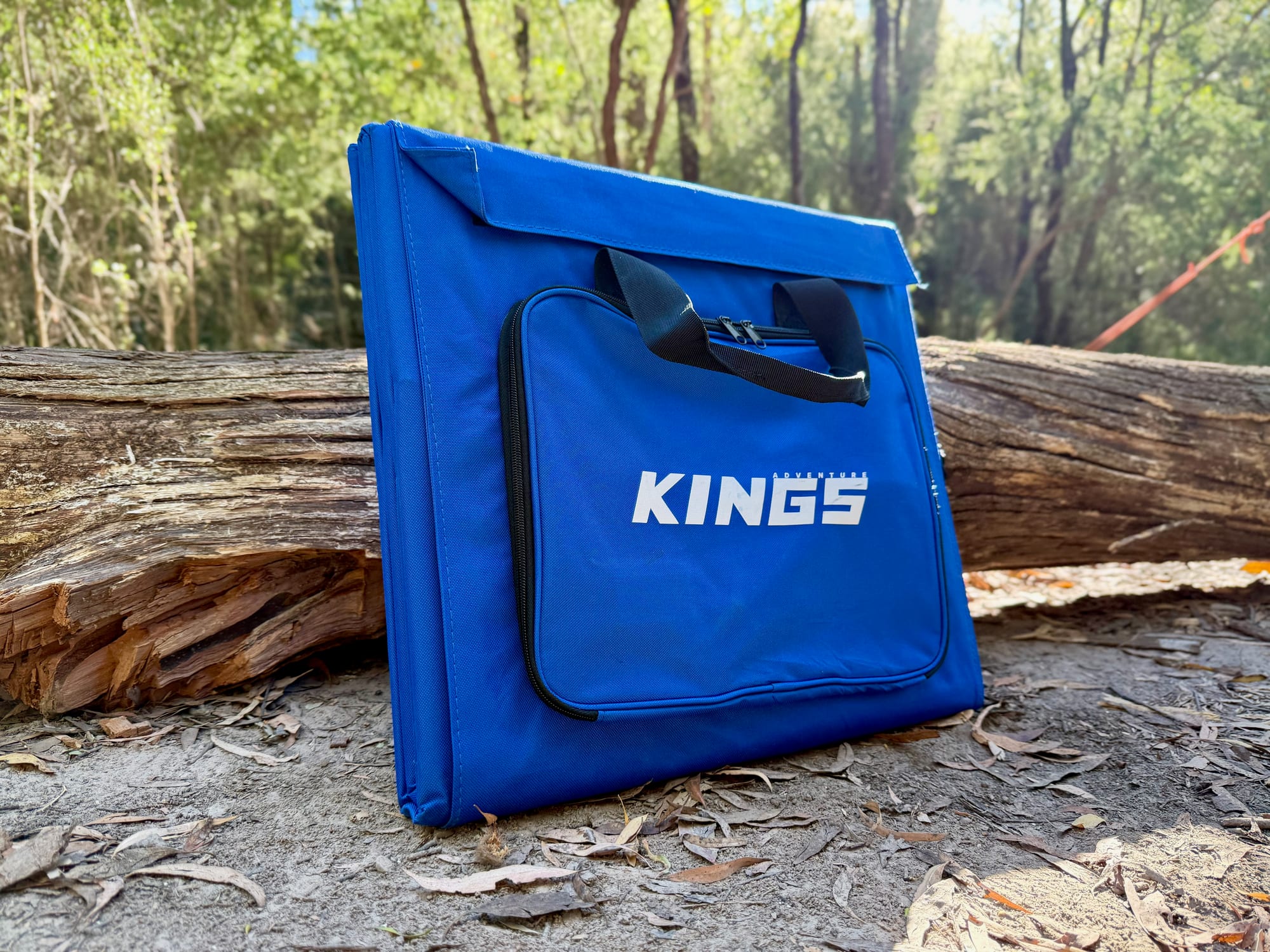 The Kings 240W solar blanket folded in its blue carry bag