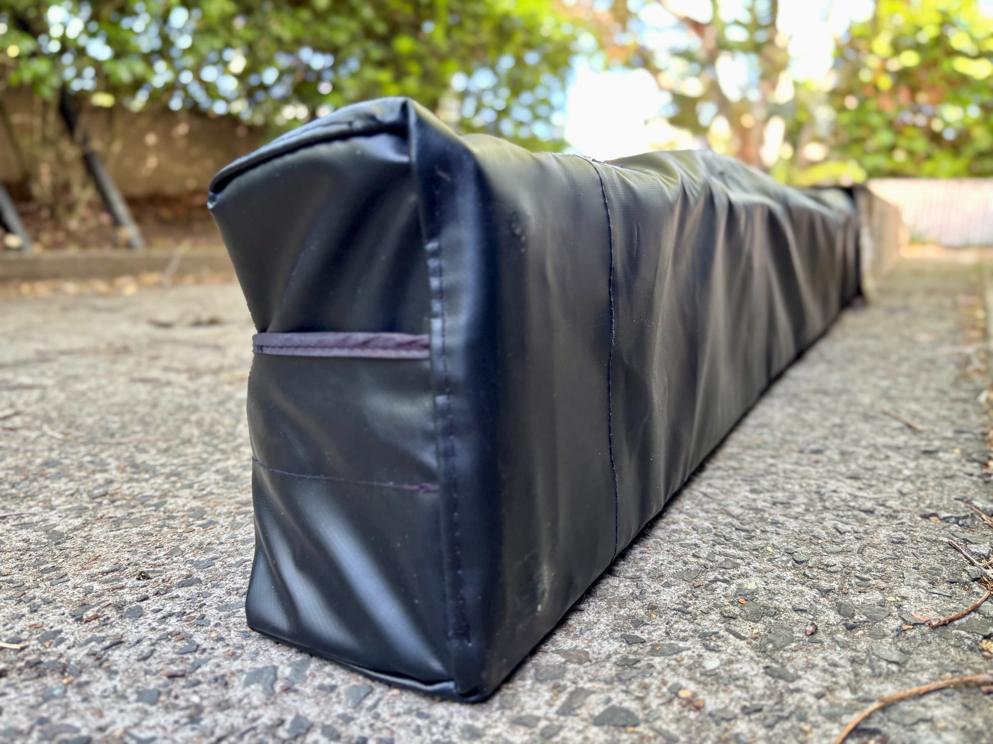 The back of the black Kings Plus awning cover, where the bolts come through