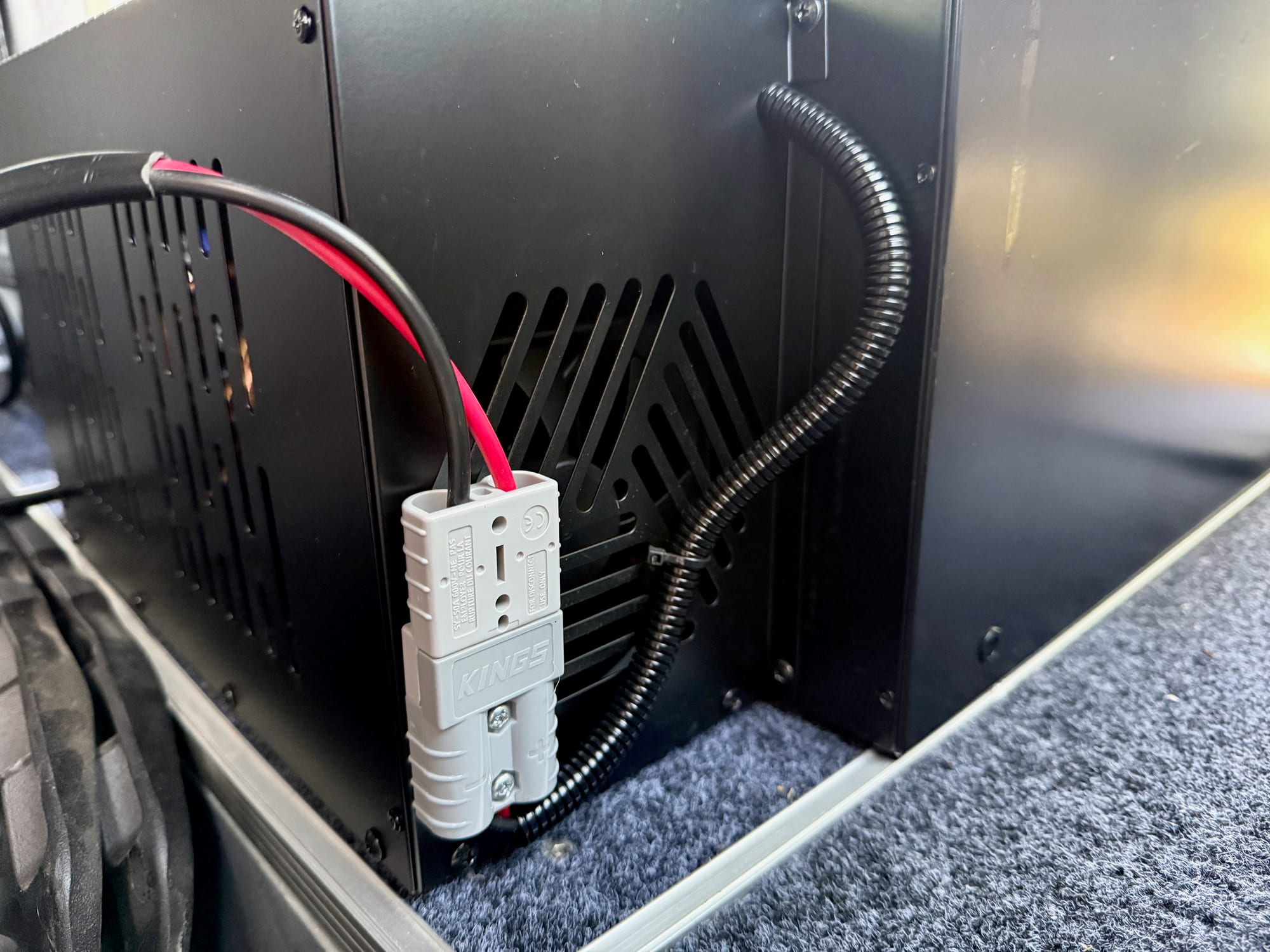 The Anderson-style plug on the power lead at the back of the Kings drawer fridge, next to the vents