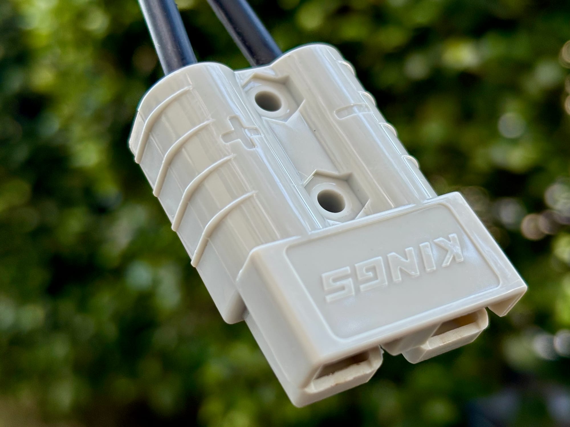 A grey Anderson-style plug with the Kings name on the end of the extension lead