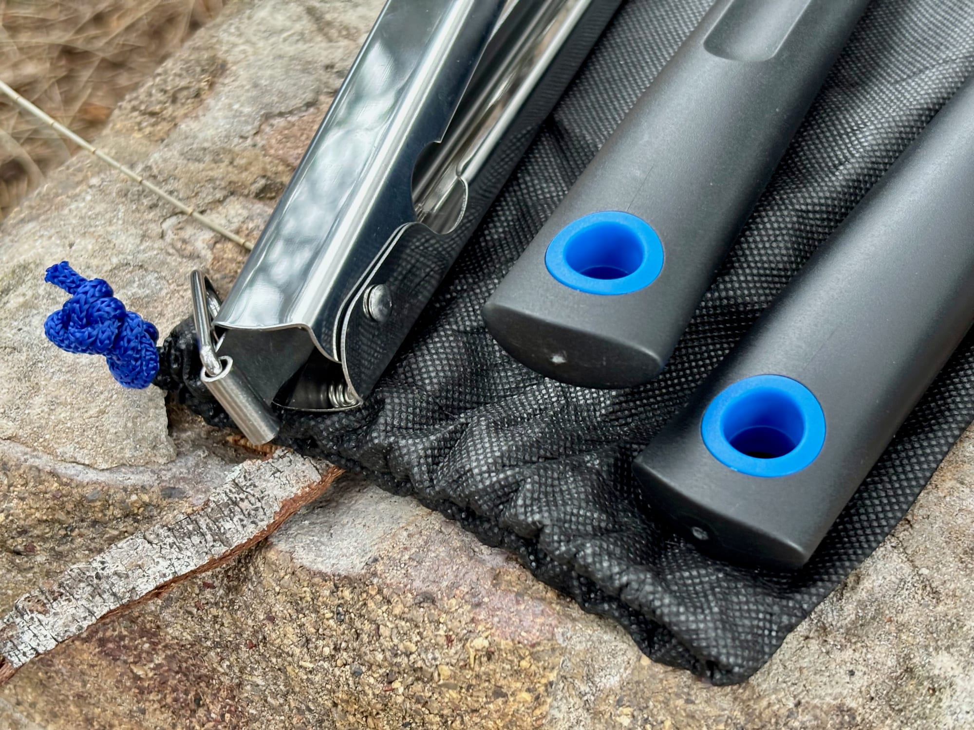 The grip handles with their blue hanging holes and the wire lock on the tongs