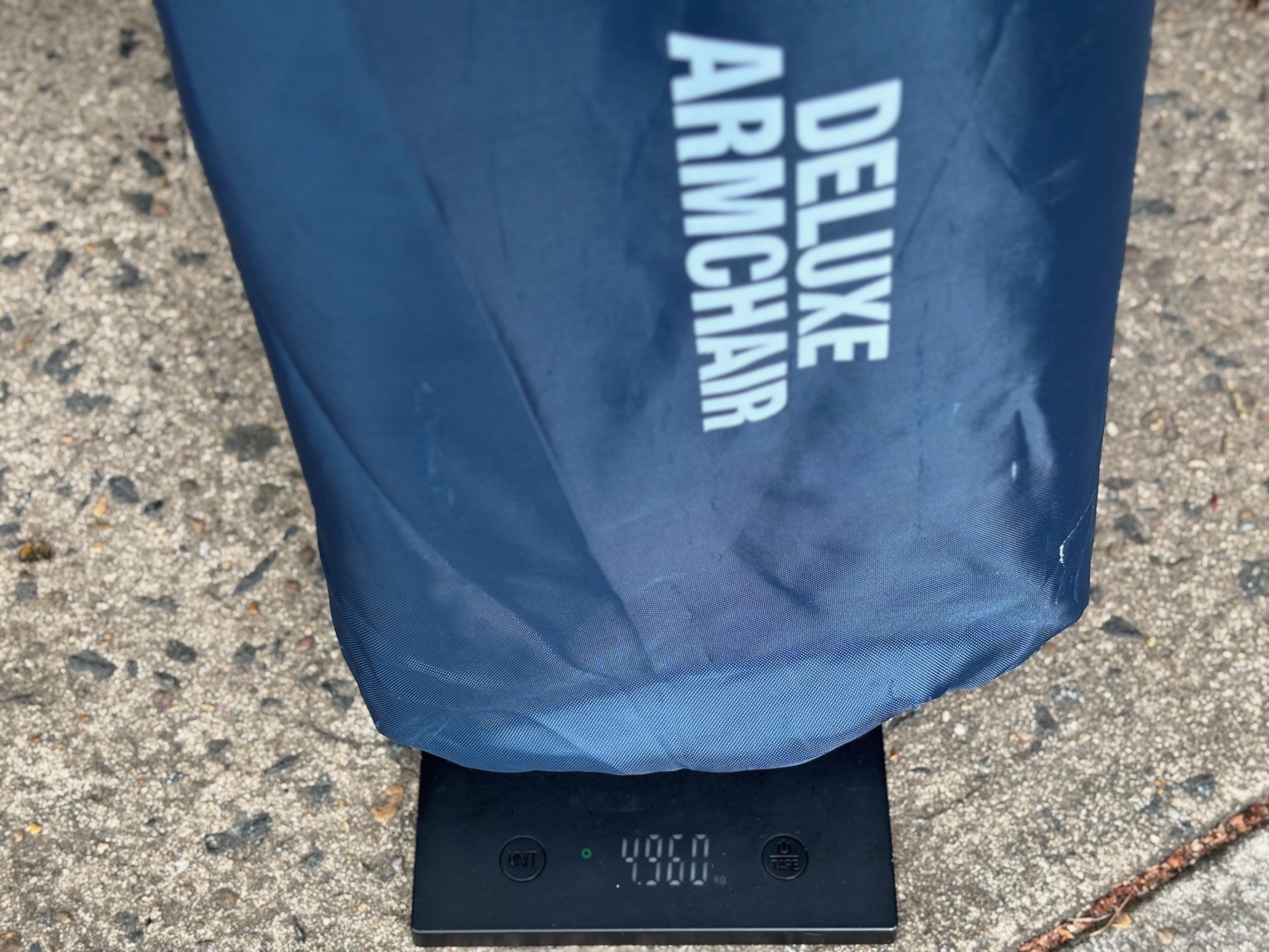 The Kings Deluxe Armchair in its bag on a kitchen scale showing 4.960 kg
