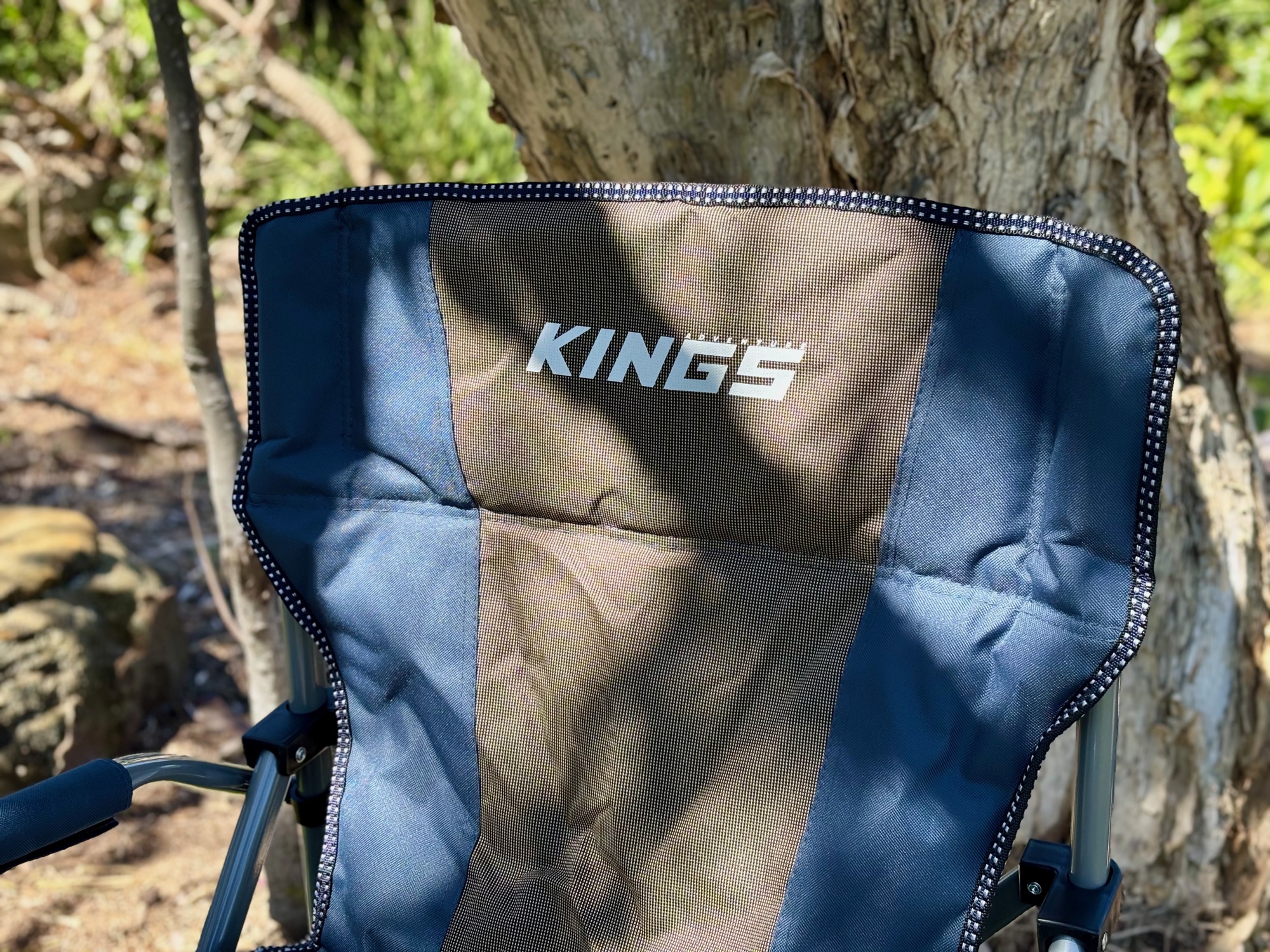 The padded backrest of the Kings Deluxe Armchair with the Kings logo