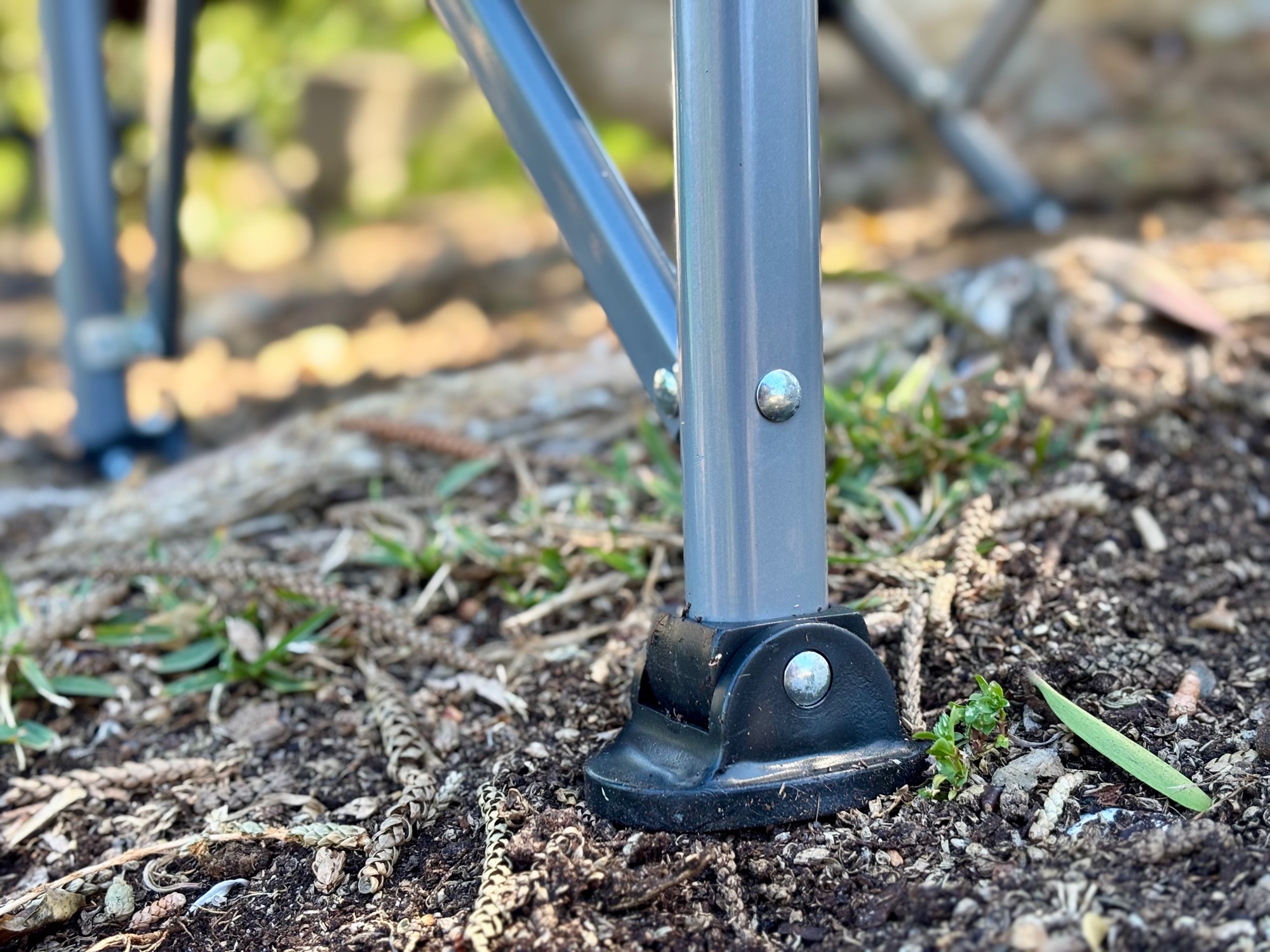 A pivoting foot of the Kings Deluxe Armchair on soft, uneven ground
