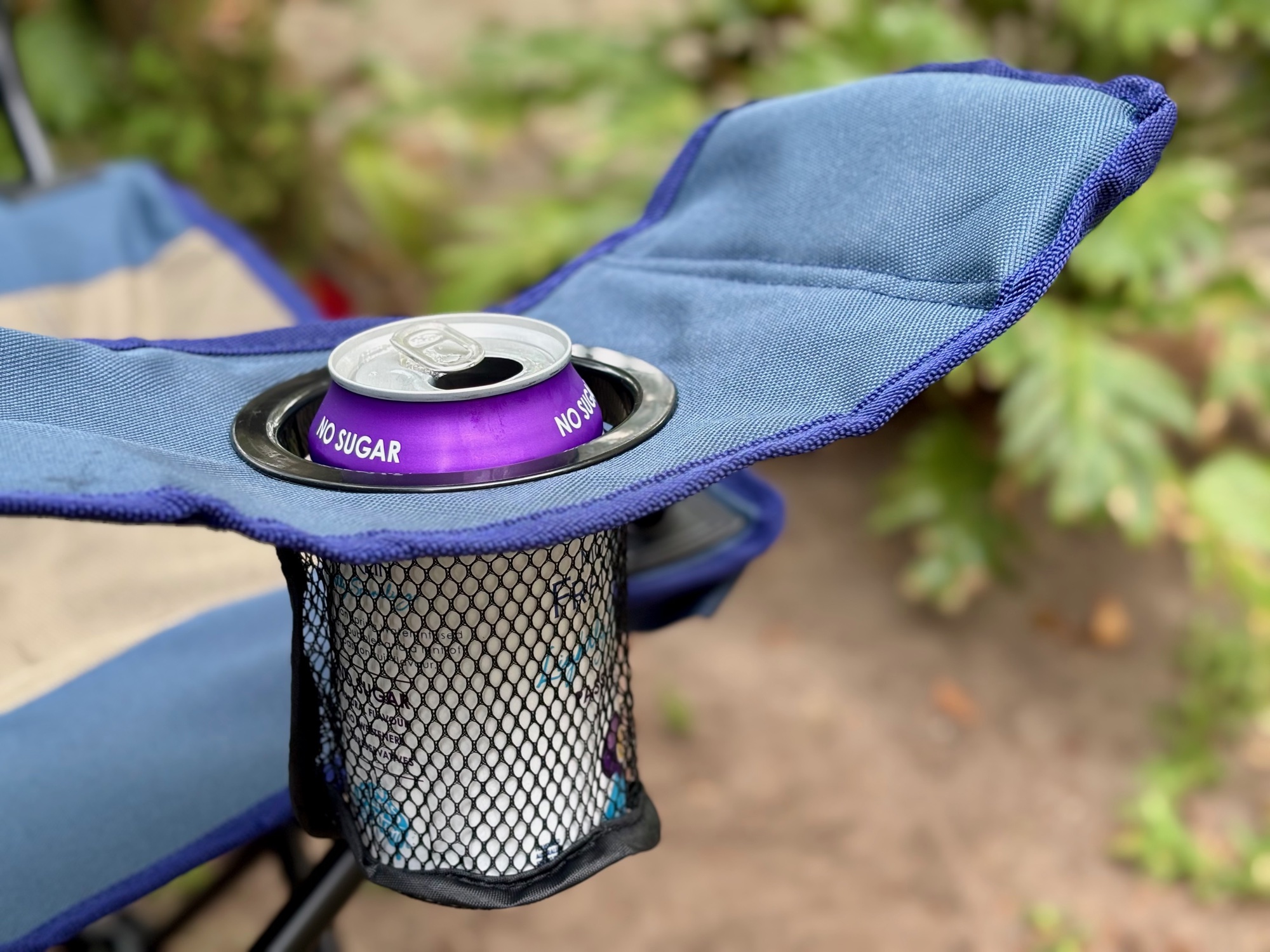 A can in the simple mesh cup holder in the armrest of the Kings Essential chair