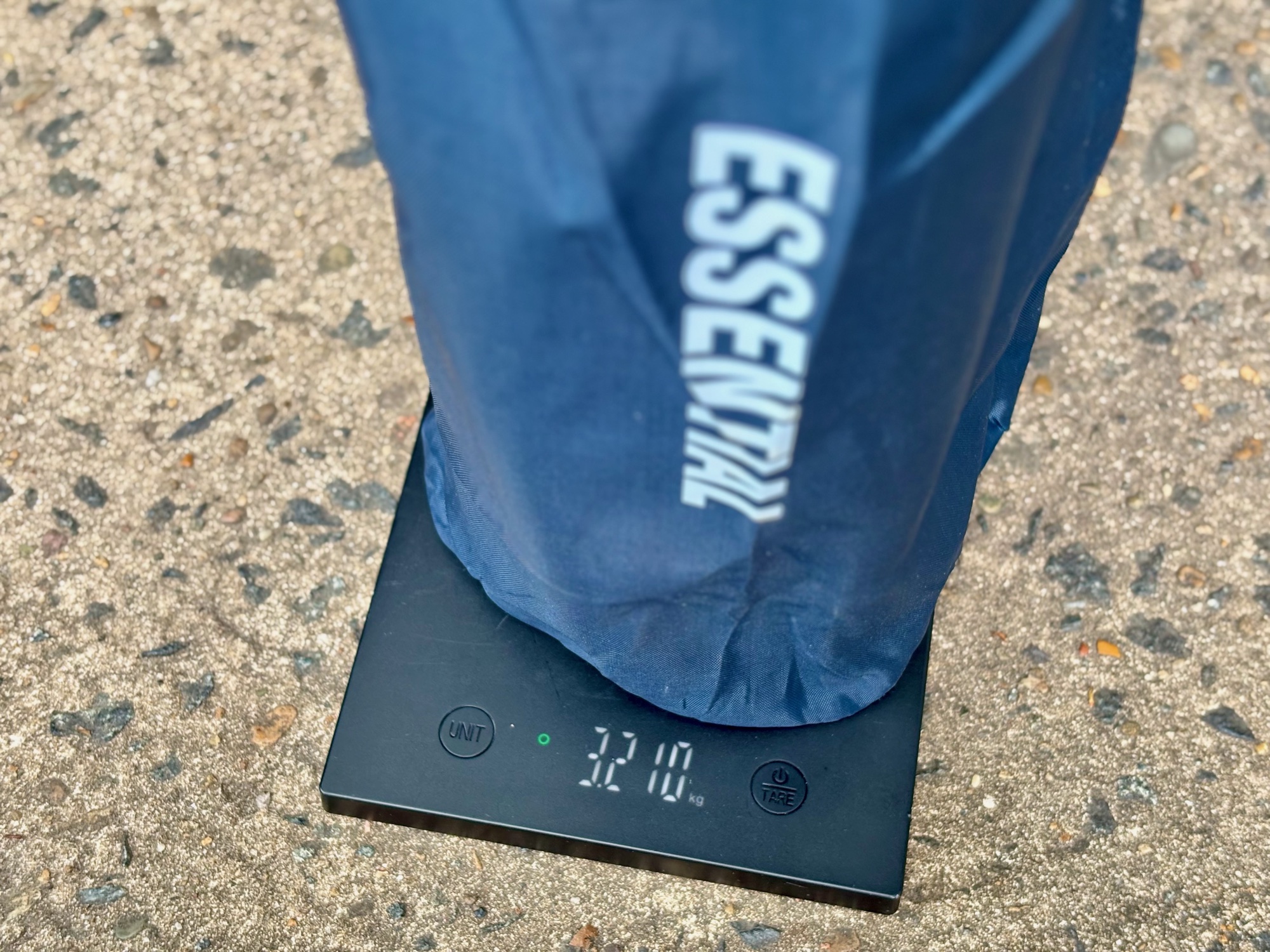 The Kings Essential Camping Chair in its bag on a kitchen scale showing 3.210 kg