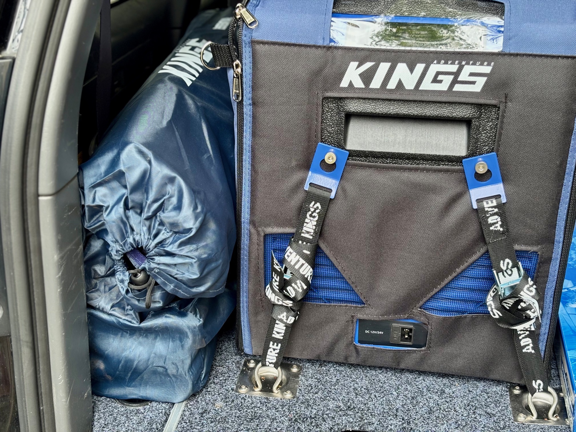 The Kings Essential chair in its bag standing in the back of the Prado next to the Kings fridge