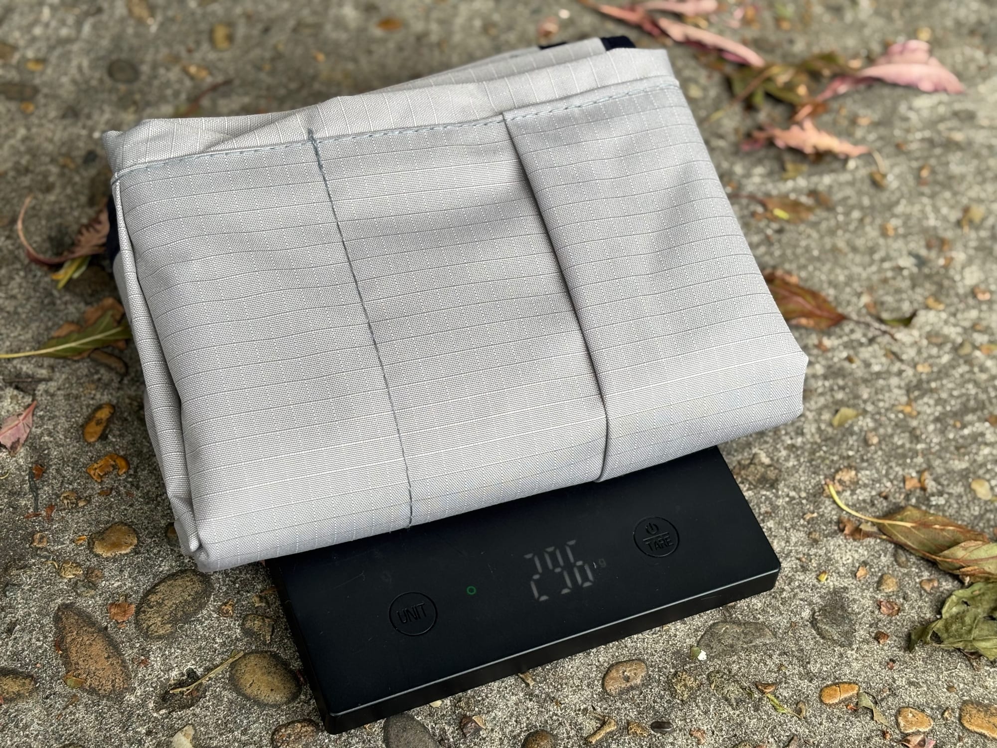 The folded grey pocket on a kitchen scale showing 296 g