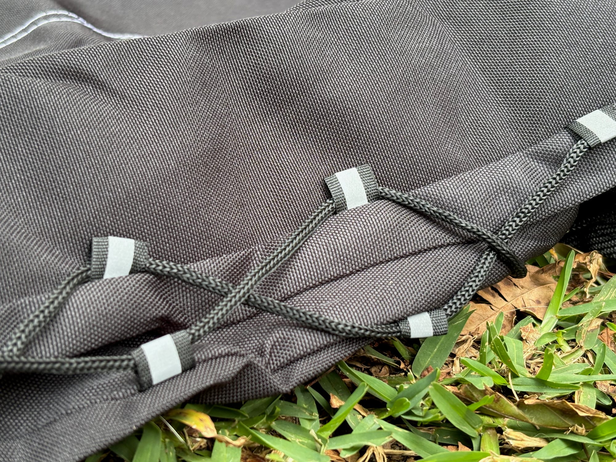 The drawstring cord laced along the edge on the underside of a Kings seat cover