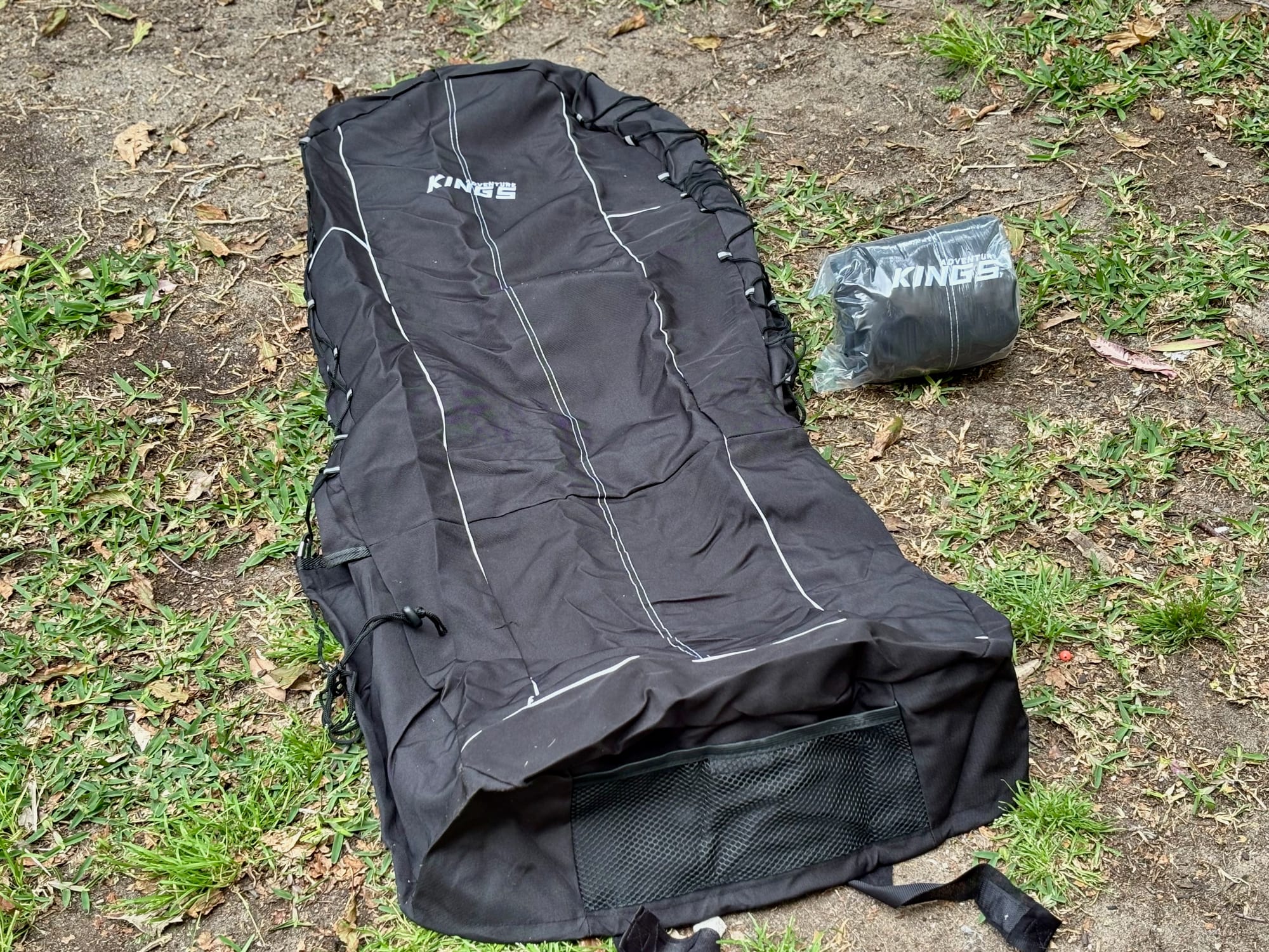 The Kings seat cover laid out flat, showing the one-piece shape with the headrest part at the top