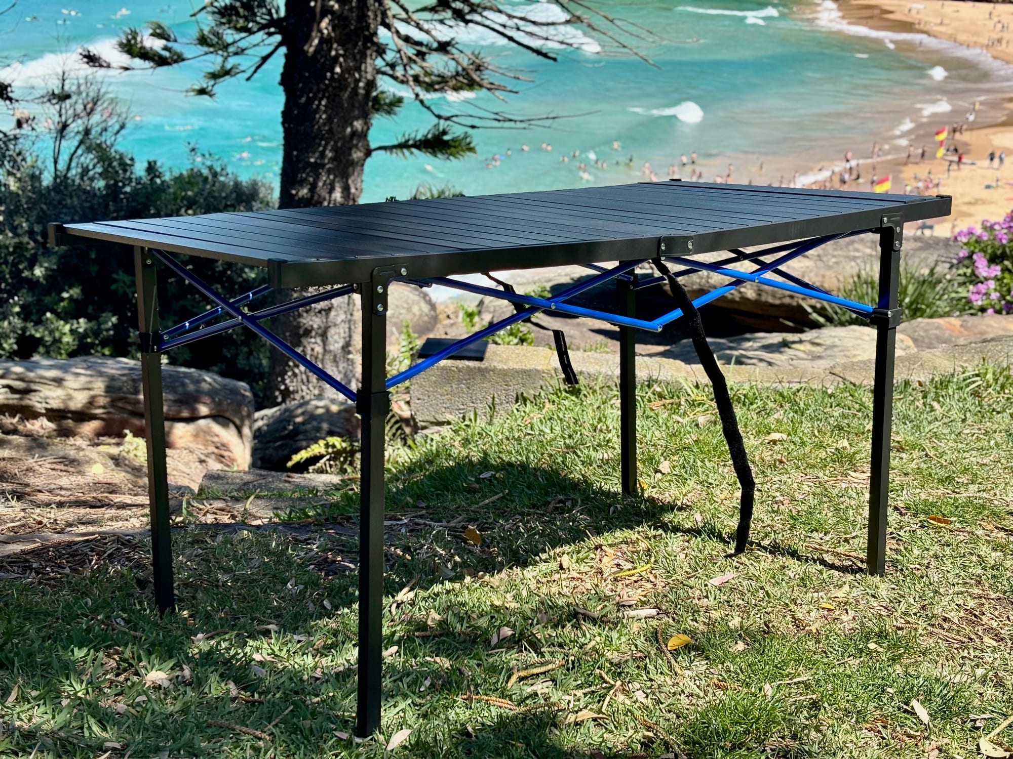 The Kings Large table from the side, set up on grass with the sea behind
