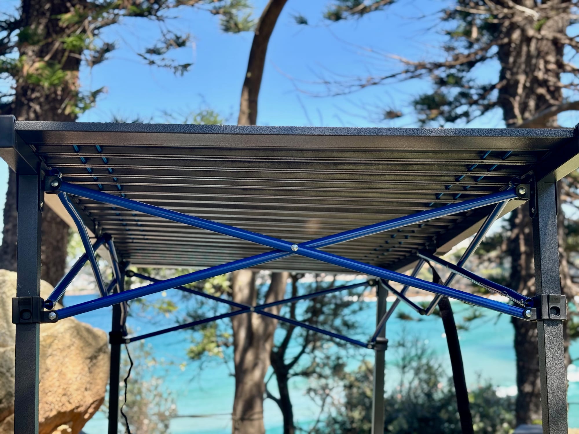 Underneath the Kings Large table: blue cross bracing under the slat top