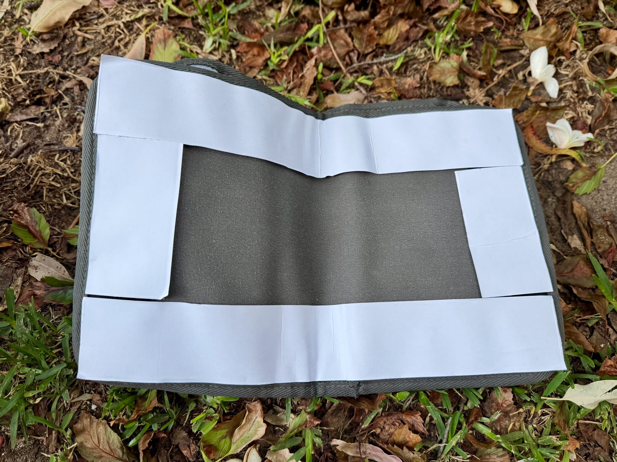 The back of the Kings Plus Pocket Organiser with the hook and loop strips and their white backing paper