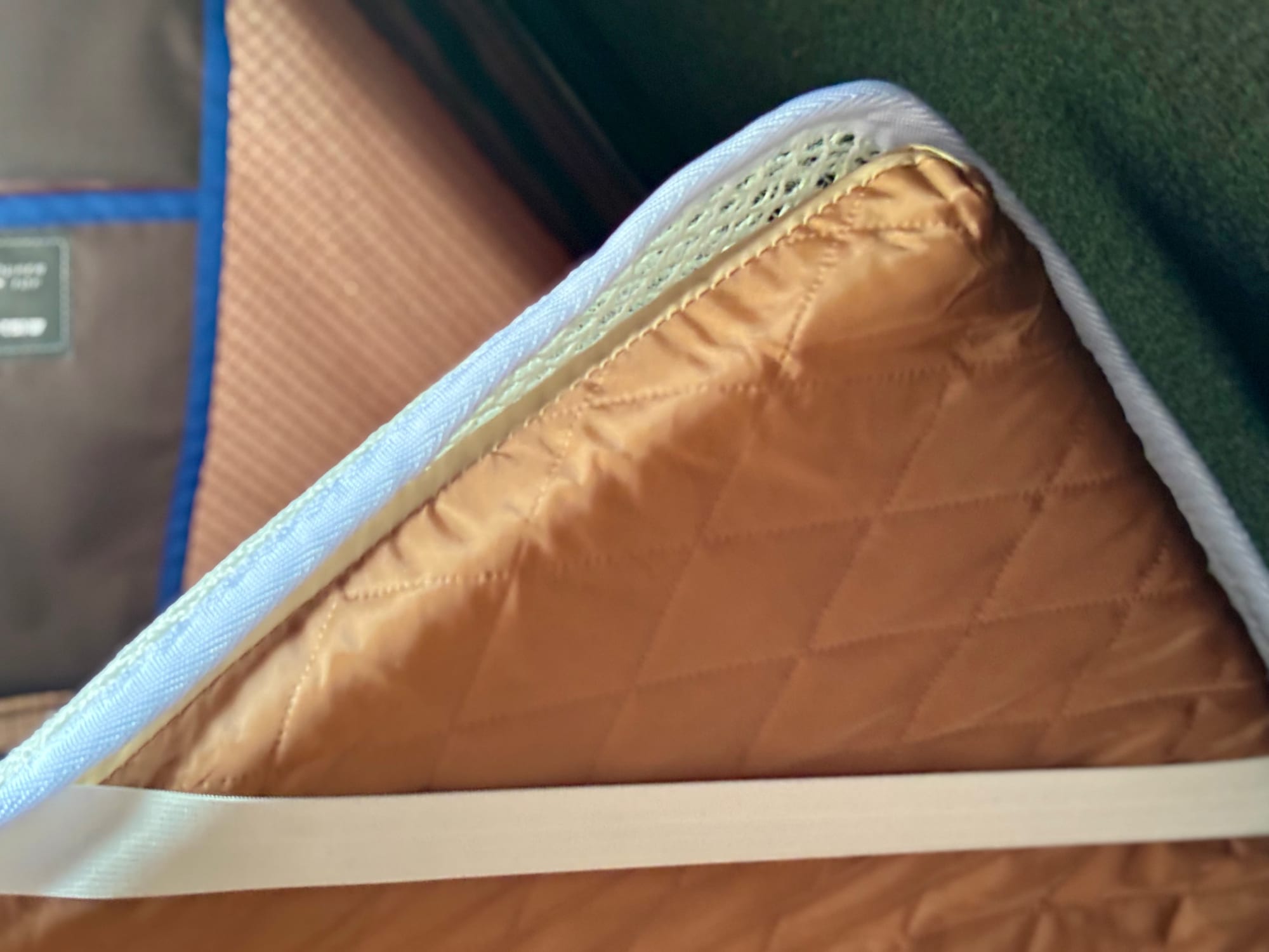 The Kings anti-condensation mat under the corner of the quilted mattress in the rooftop tent